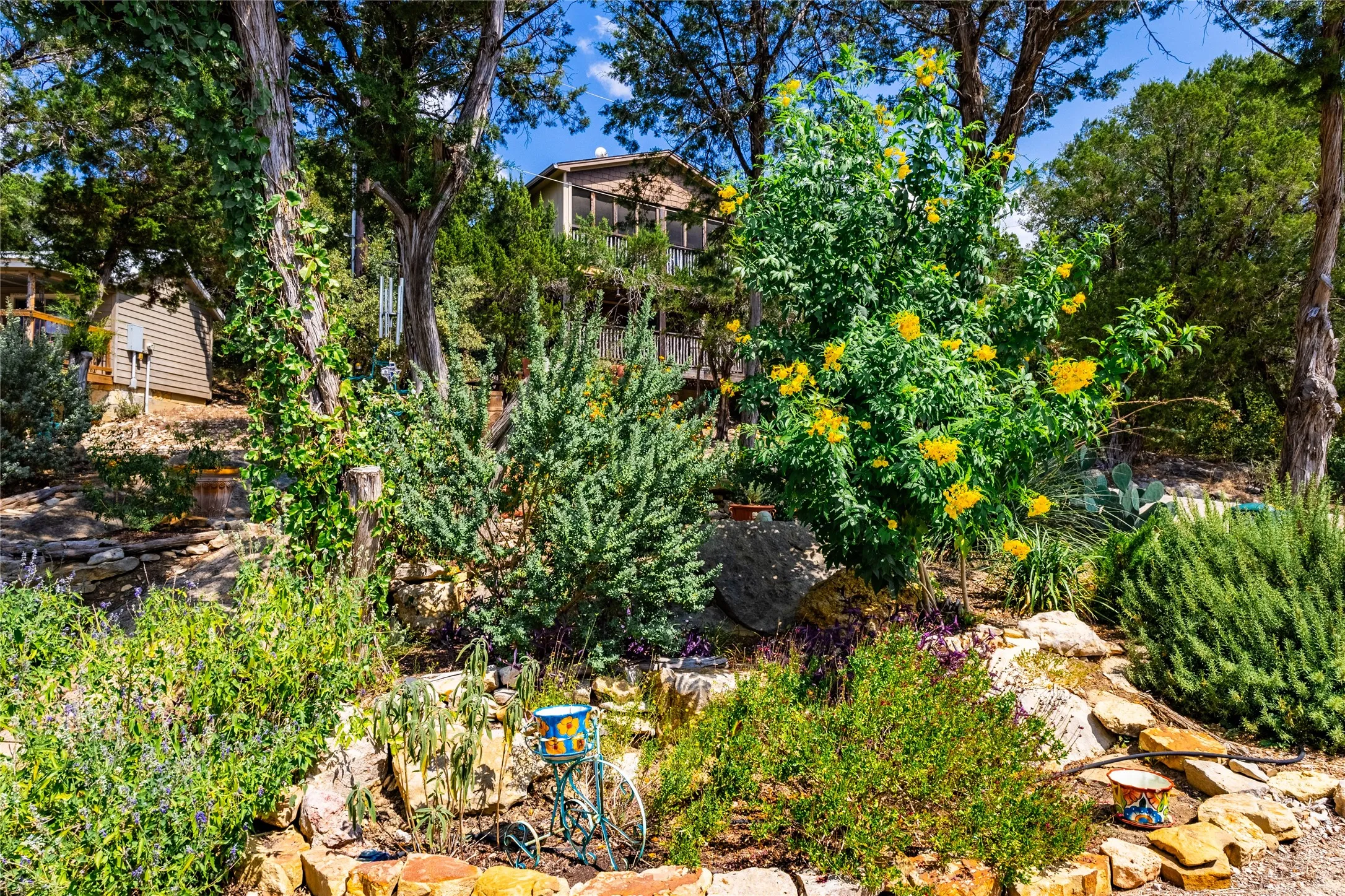 Filled with hardy florals and greenery, this gorgeous garden spot can be yours!
