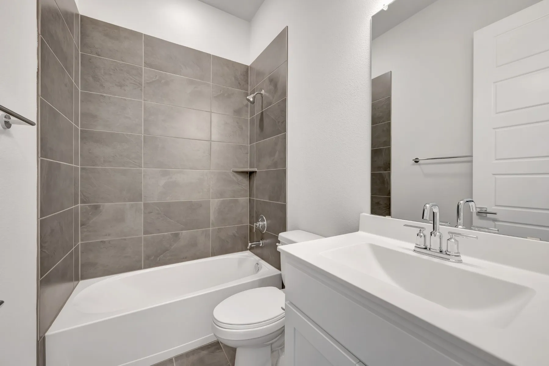 Bathroom featuring vanity and shower / bathtub combination