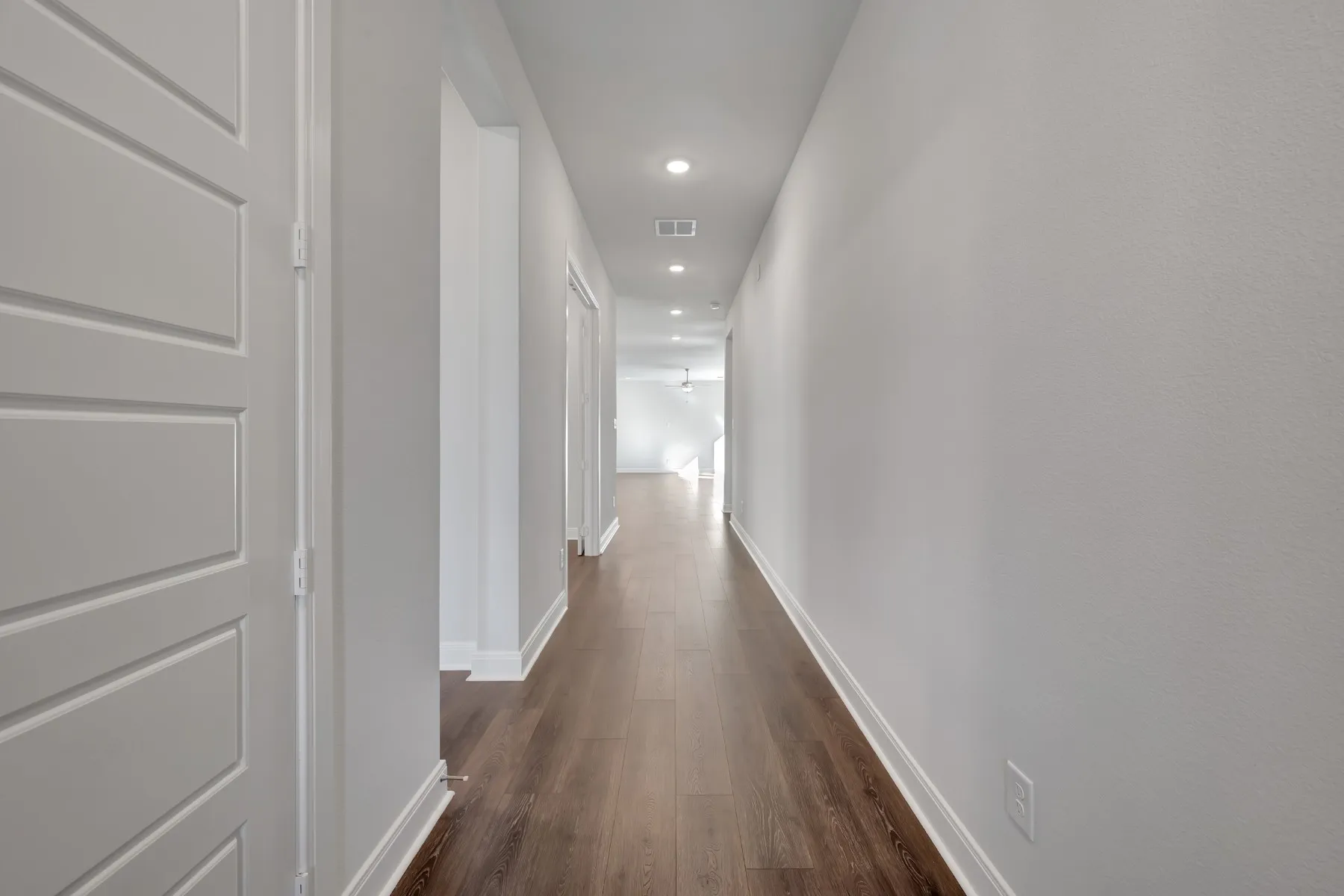 Hallway with recessed lighting and dark wood-type flooring