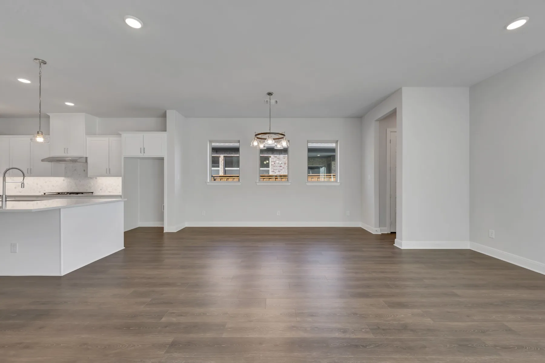 Unfurnished dining area with recessed lighting and dark wood finished floors