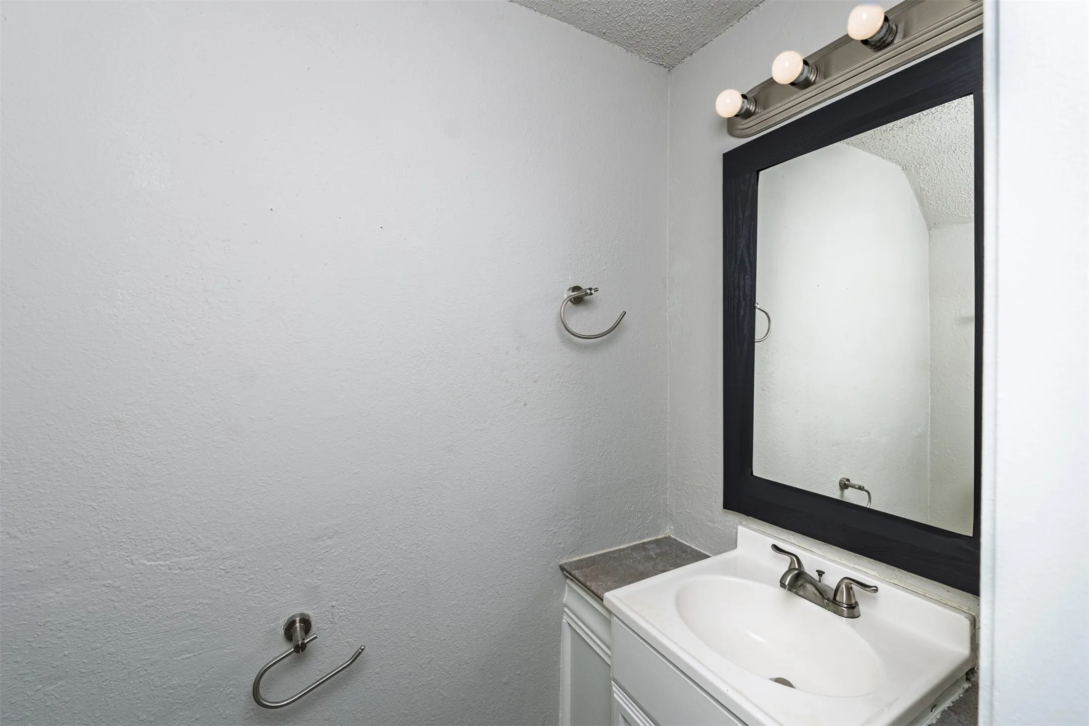 Bathroom featuring vanity and a textured ceiling