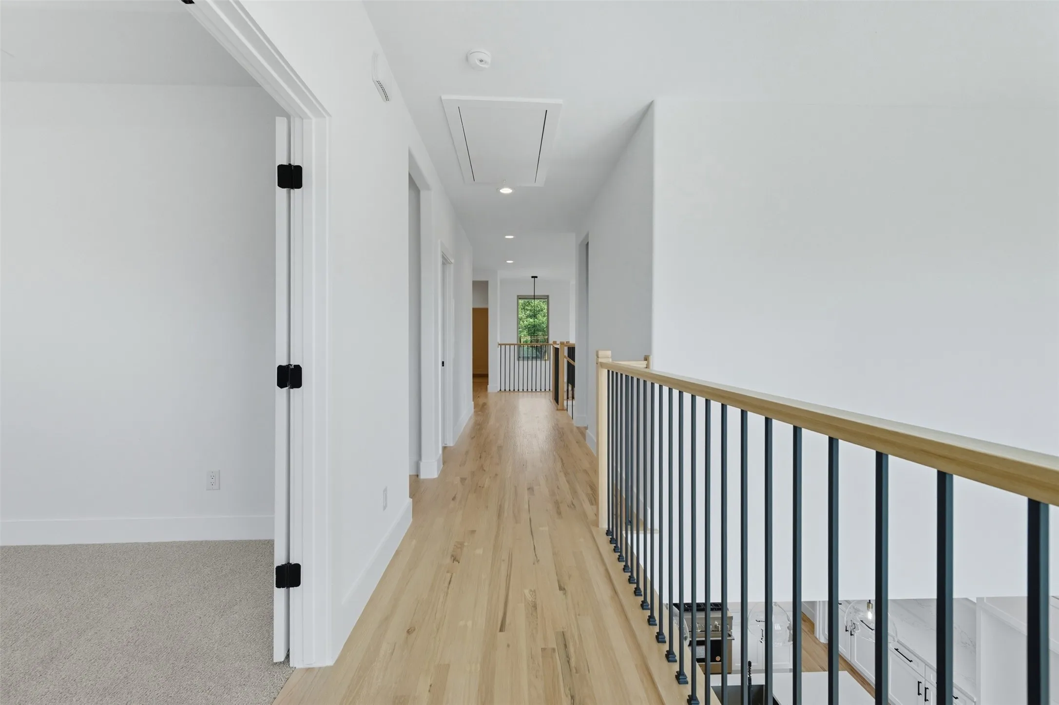 Hall with attic access, recessed lighting, and light wood-type flooring
