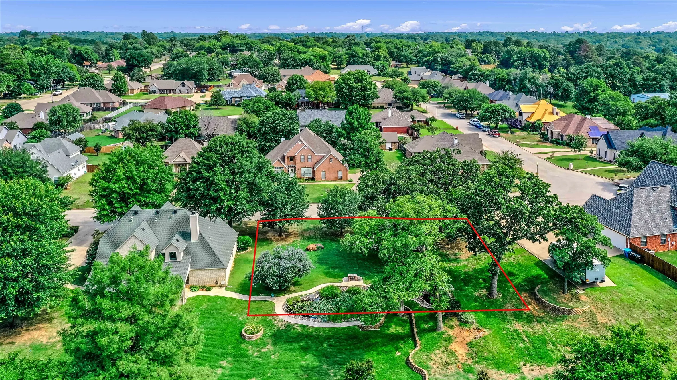 Aerial perspective of suburban area with property parcel outlined