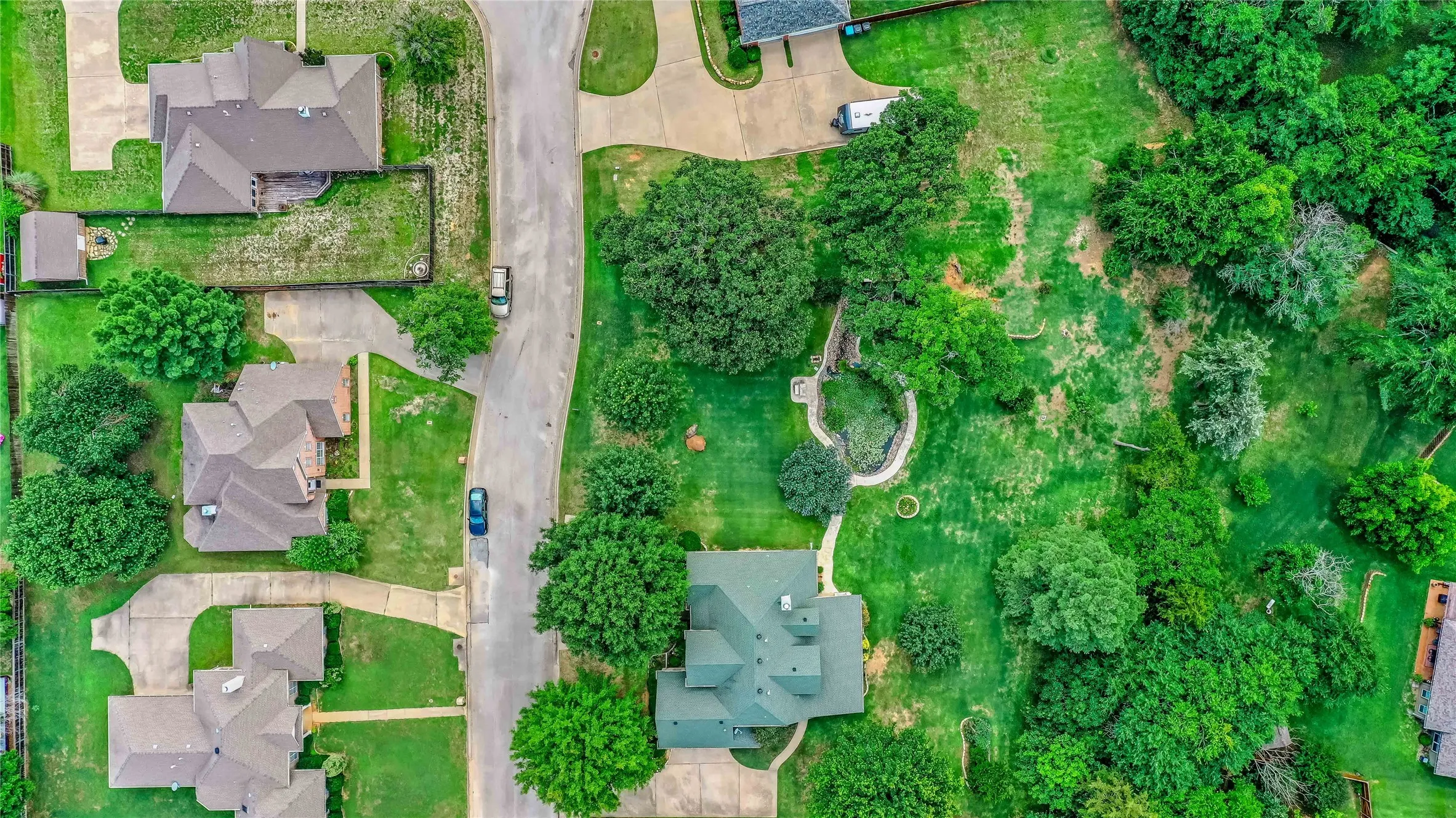 Aerial view of property and surrounding area with nearby suburban area