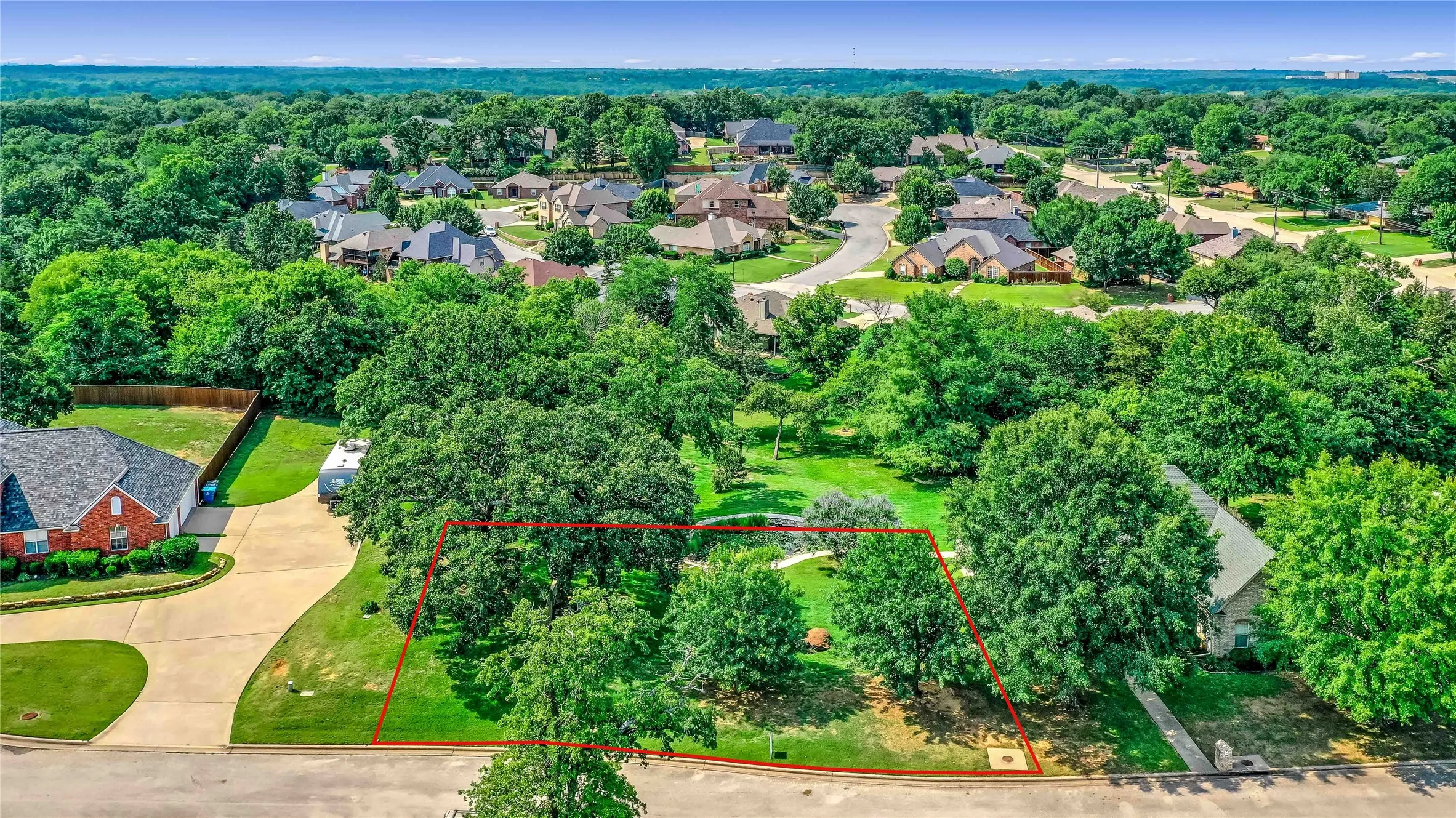 Aerial perspective of suburban area featuring property parcel outlined
