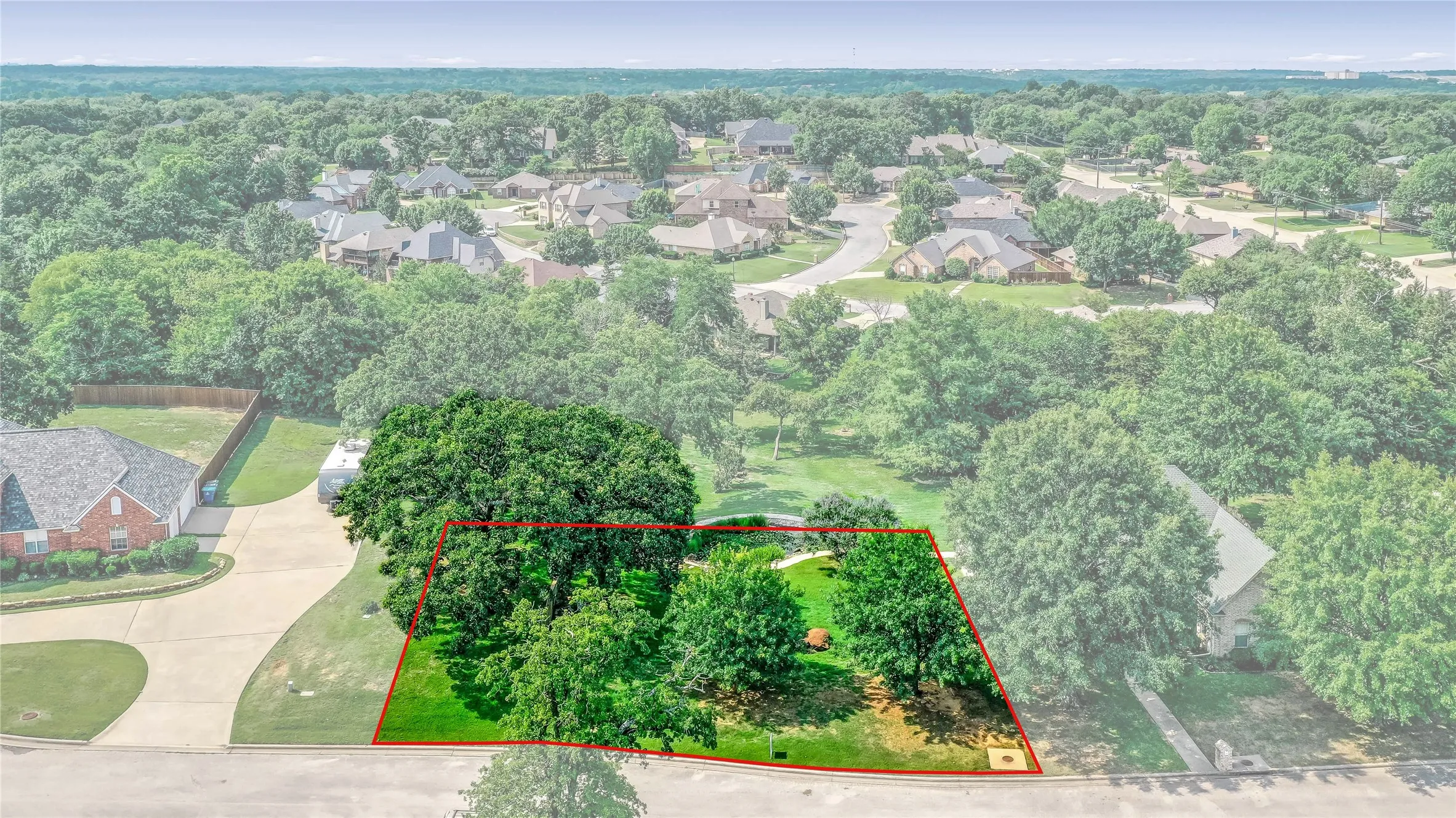 Aerial view of residential area with property parcel outlined