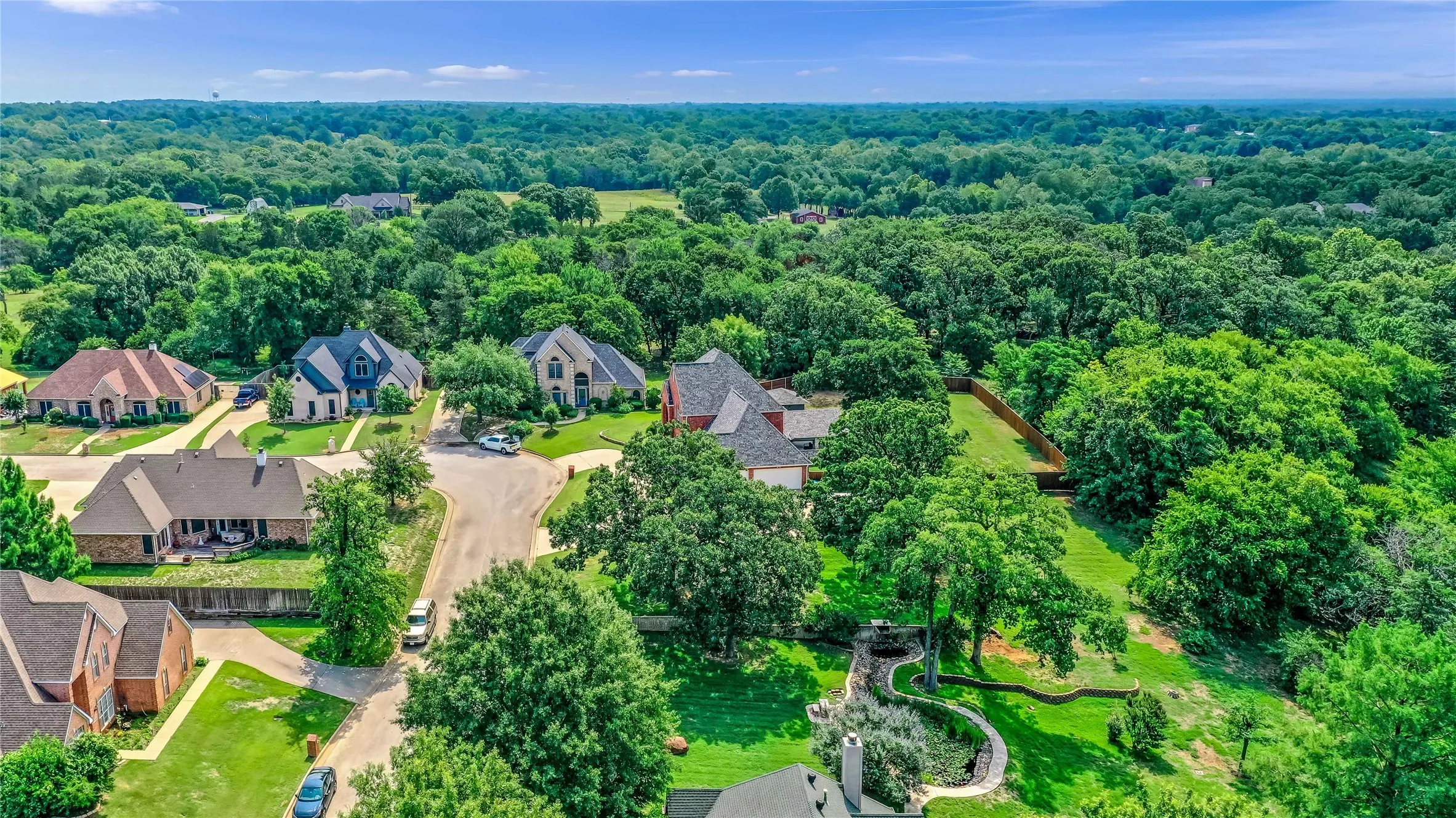 Aerial view of residential area with a heavily wooded area