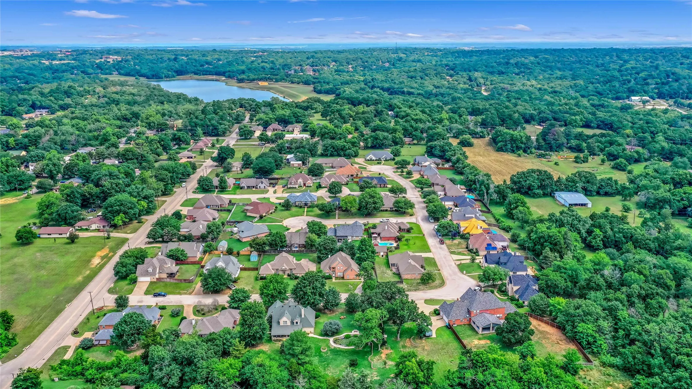 Aerial perspective of suburban area with a nearby body of water