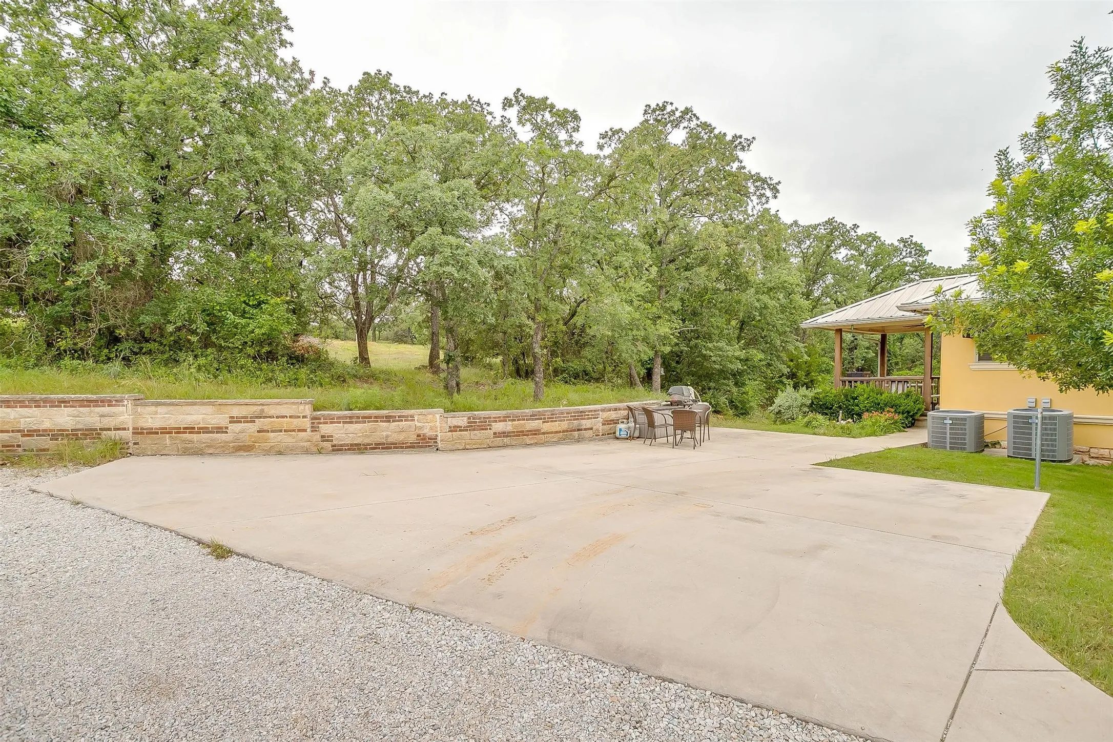 Side view of main residence that shows parking and street level entrance.  On the other side of the residence is a outside stairs to the porch as well.