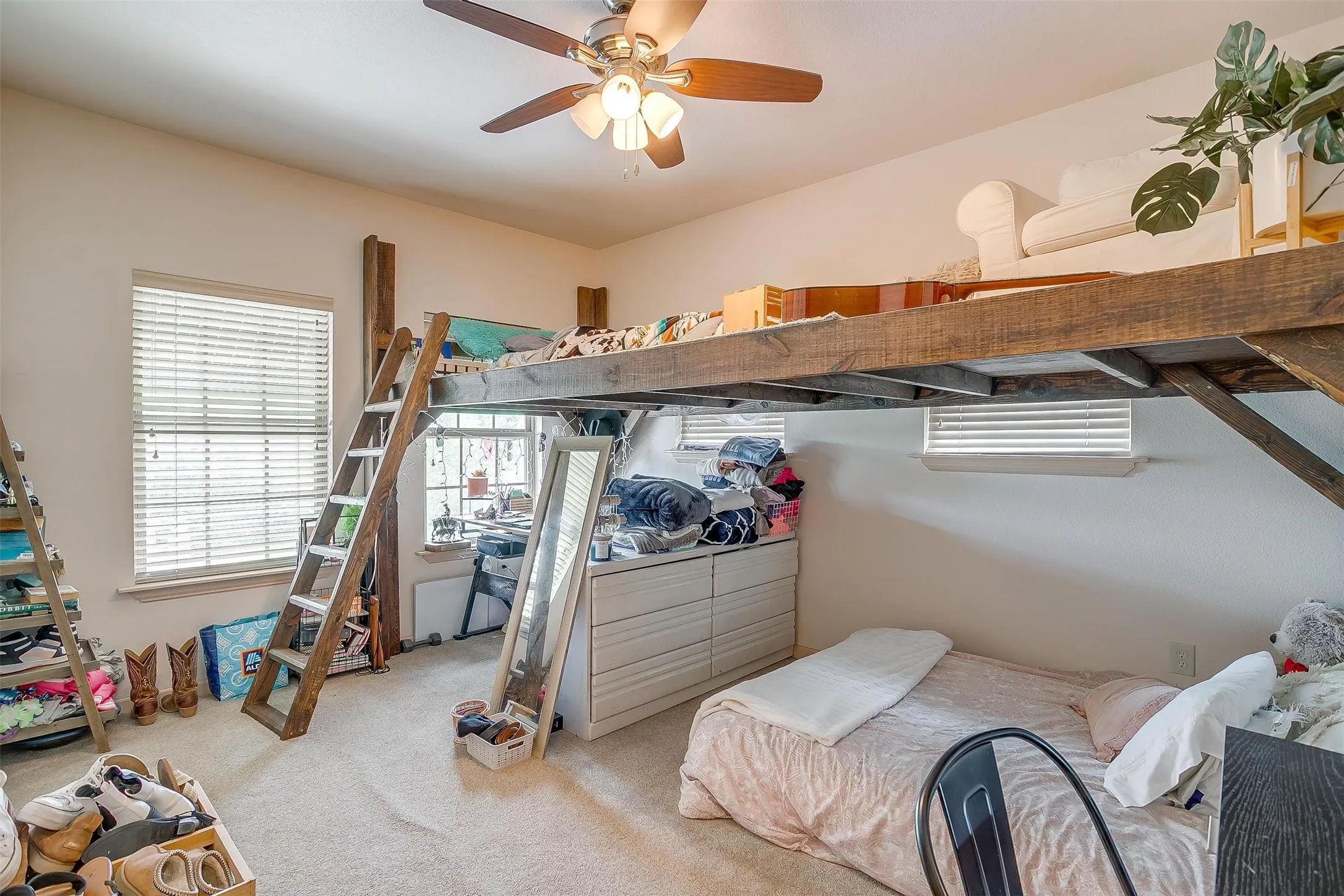 B2of 2 guest bedroom with light colored carpet and ceiling fan. Includes custom kid-loft.