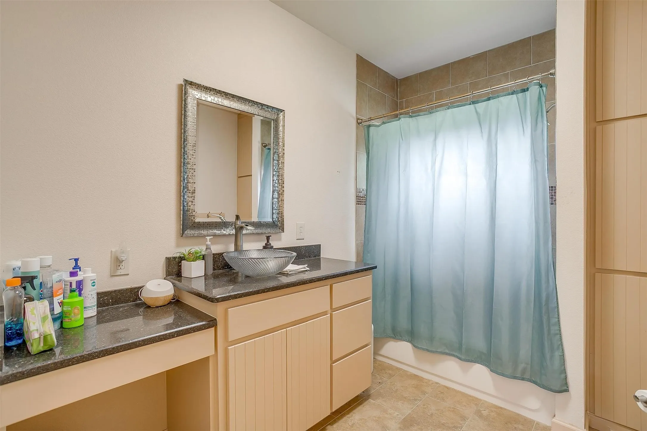 Bathroom with shower / bath combo and vanity