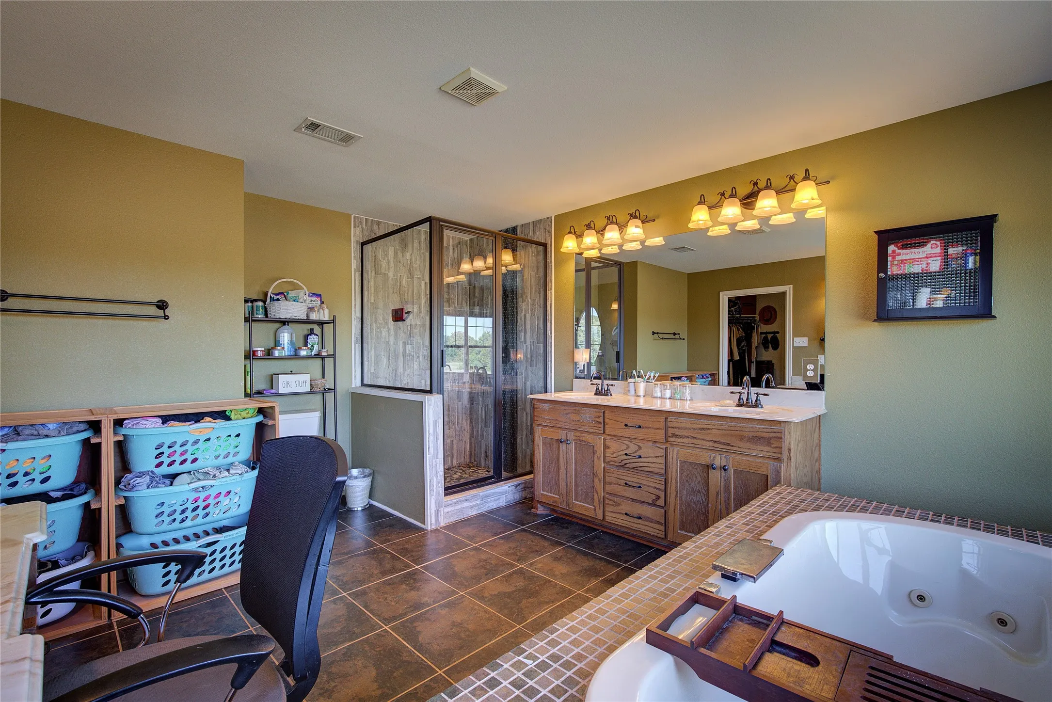 Bathroom featuring separate shower and tub, tile patterned floors, and vanity