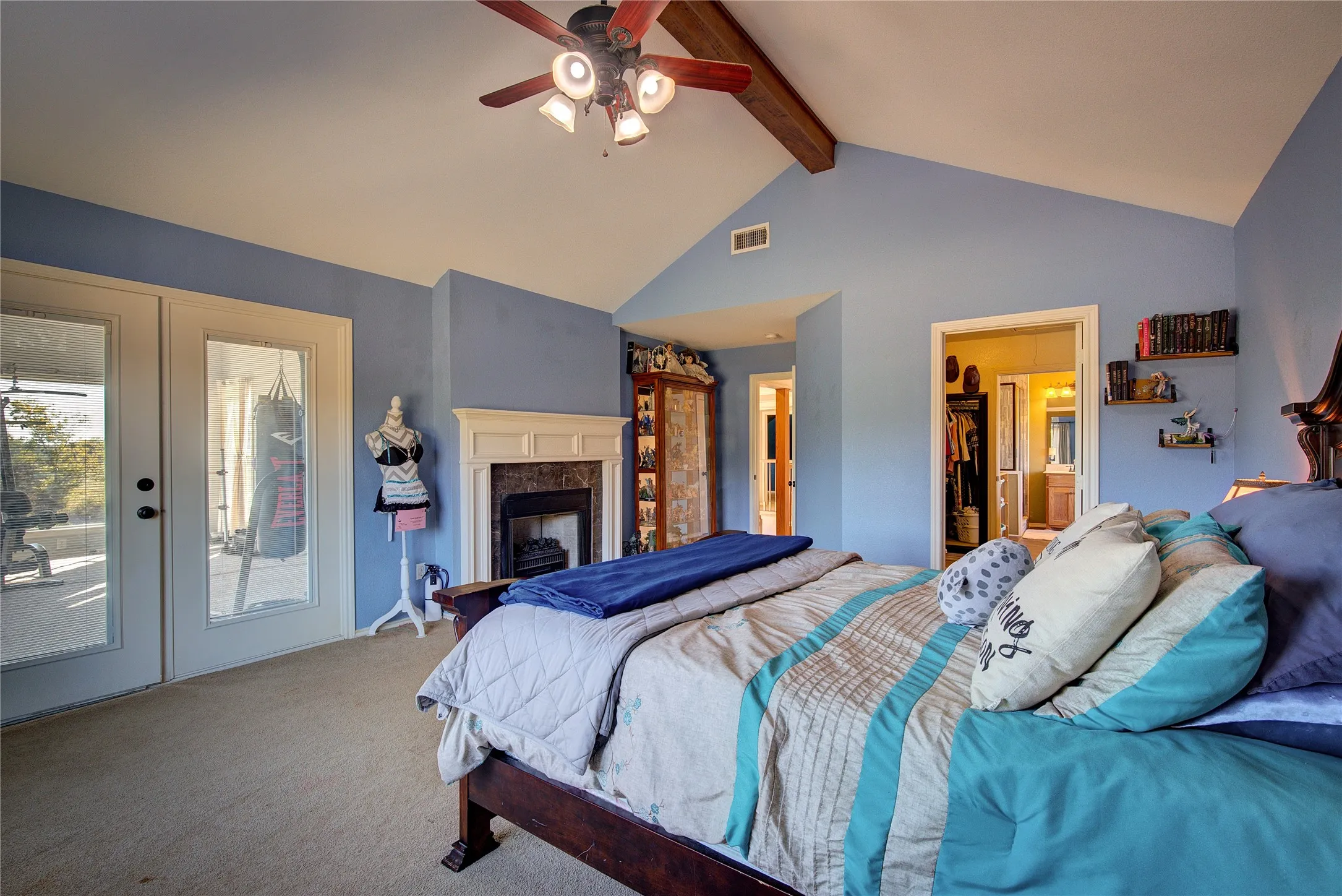 Carpeted bedroom with a high end fireplace, french doors, ceiling fan, access to exterior, and beamed ceiling