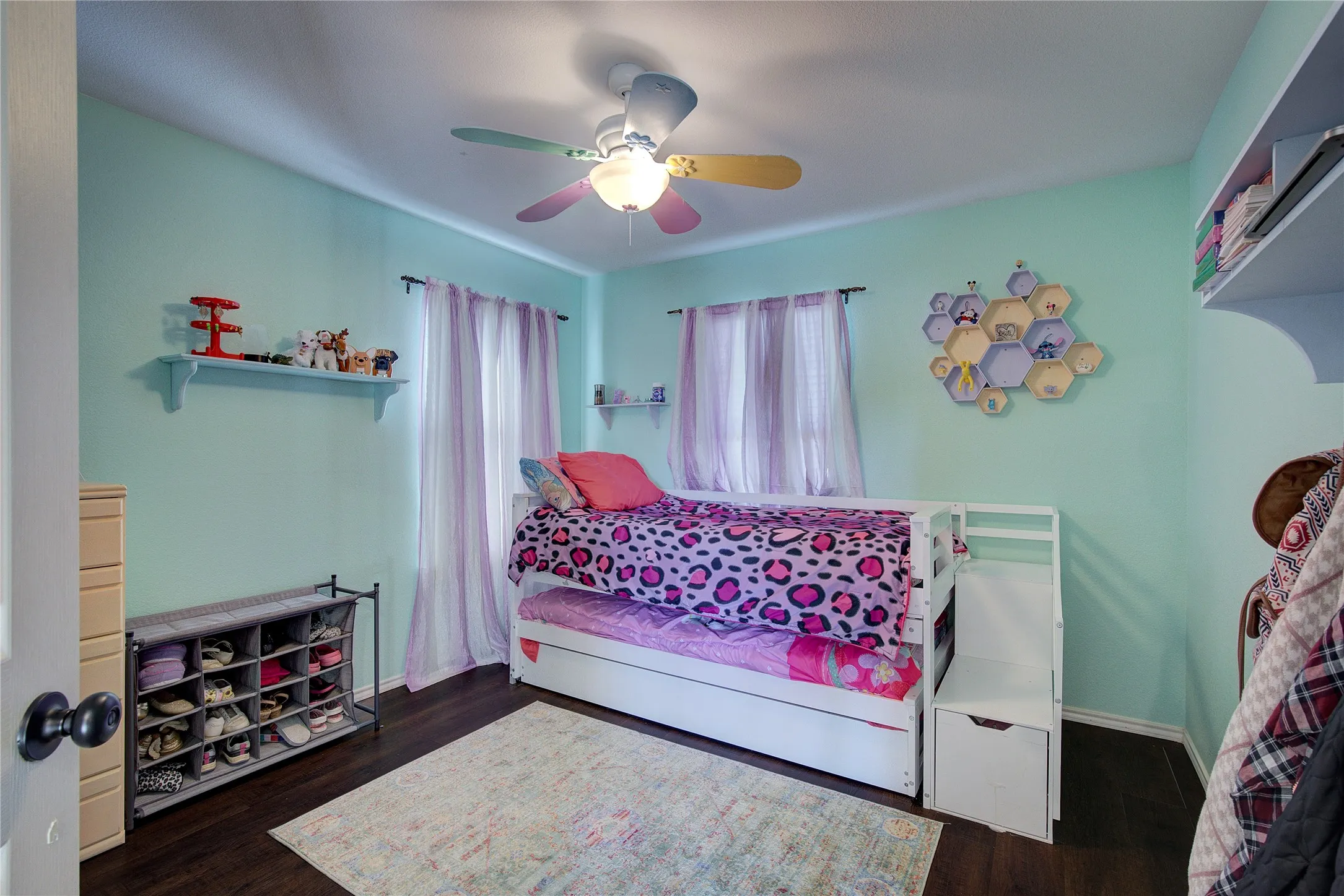 Bedroom featuring ceiling fan and dark wood-type flooring