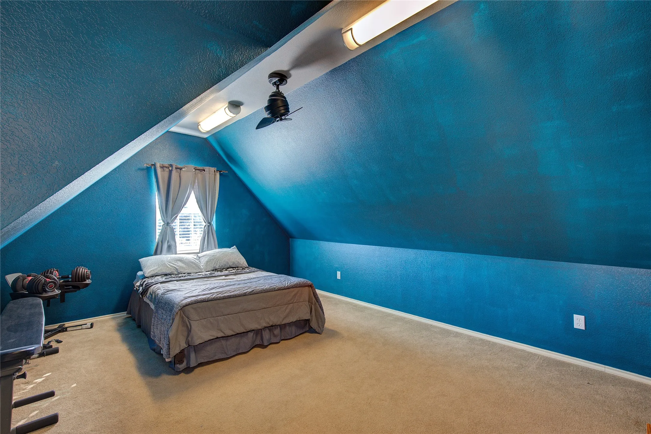 Bedroom featuring a textured ceiling, carpet floors, ceiling fan, and lofted ceiling