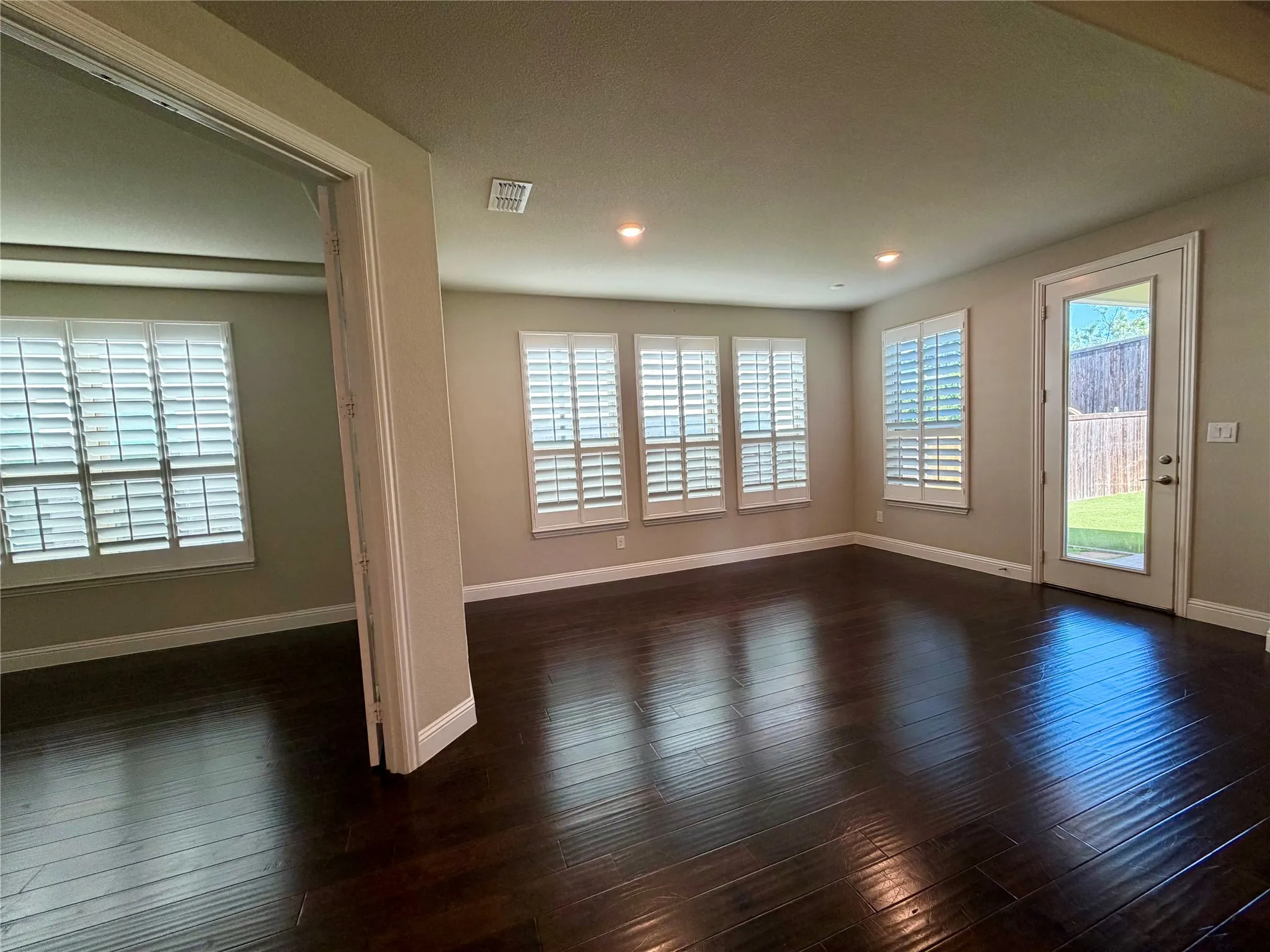 Unfurnished breakfast nook with plenty of natural light, dark wood-style flooring, and recessed lighting
