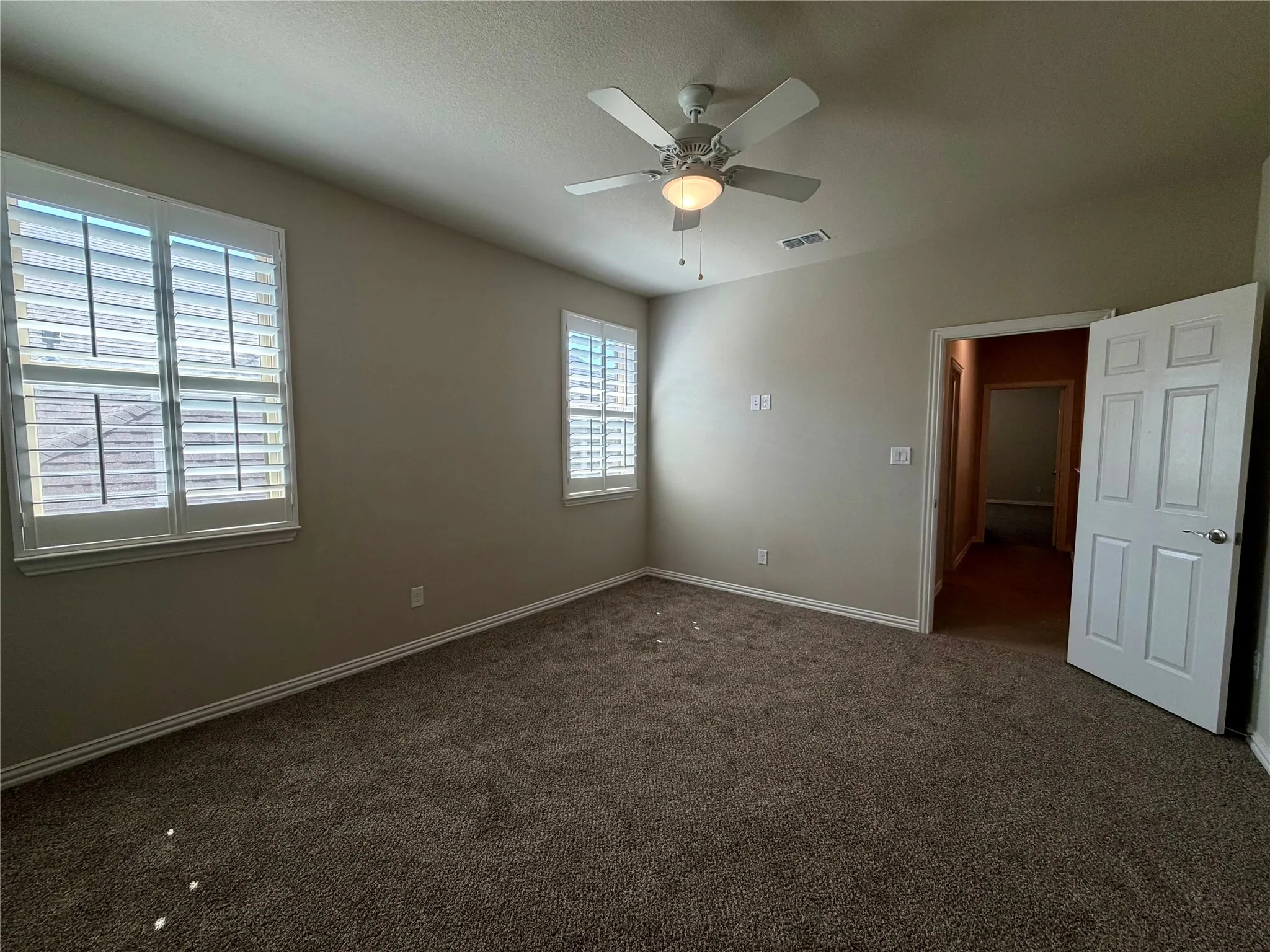 Unfurnished bedroom with carpet and ceiling fan
