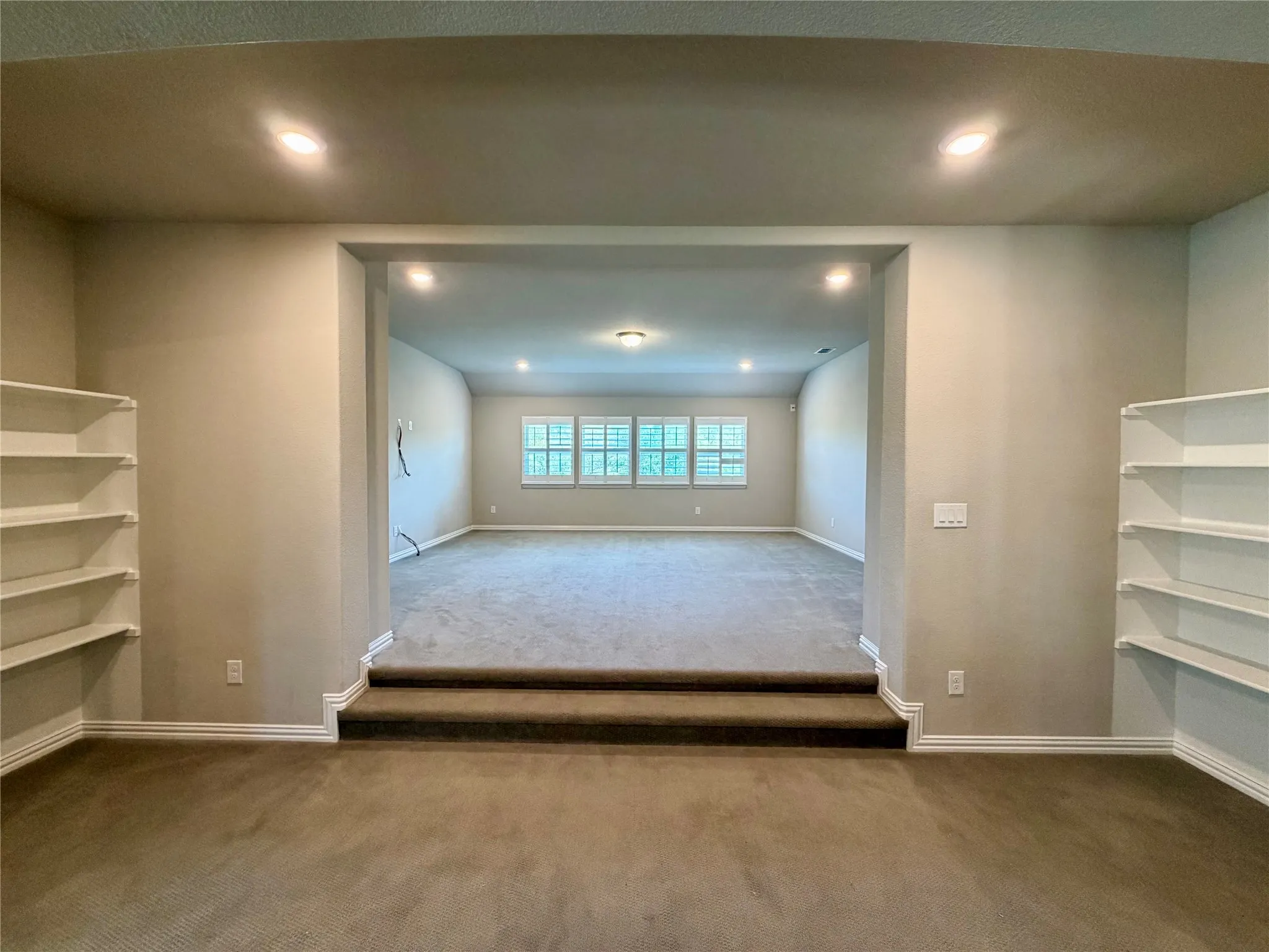 Bonus room with carpet flooring and recessed lighting