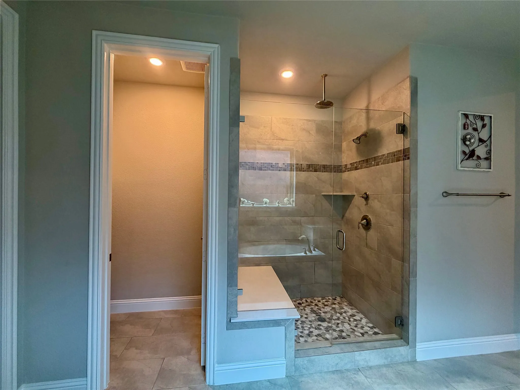 Primary Bathroom with a shower stall and tile patterned floors