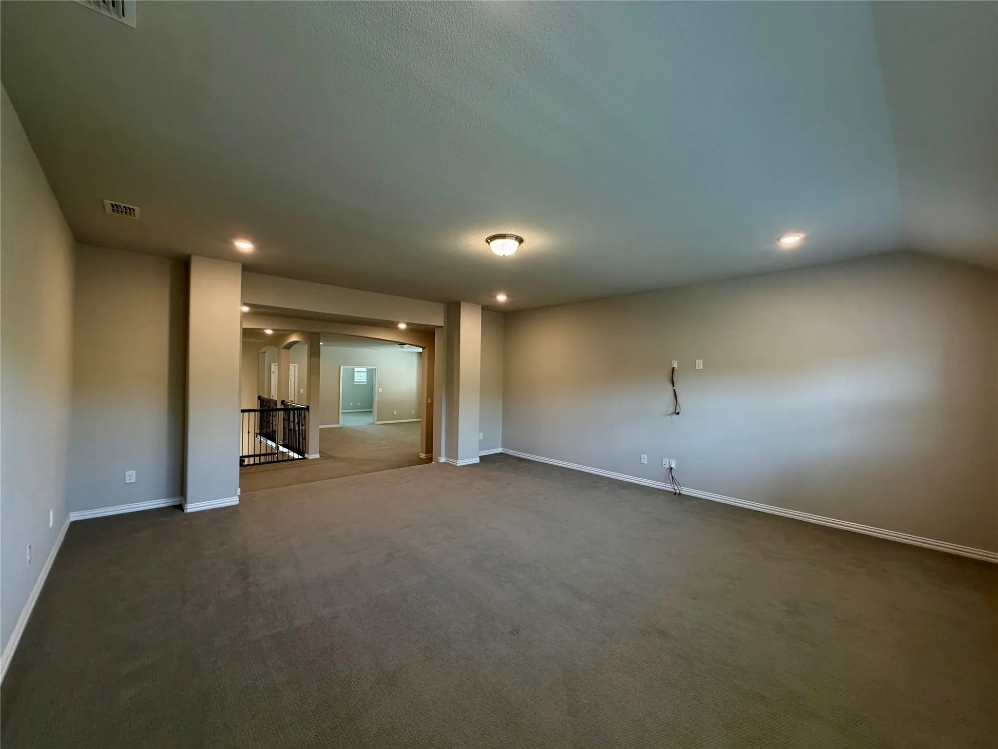 Bonus room with carpet flooring and recessed lighting