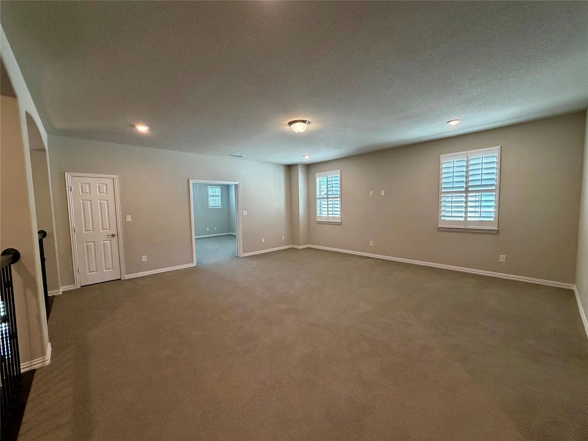 Game room with carpet flooring and a textured ceiling