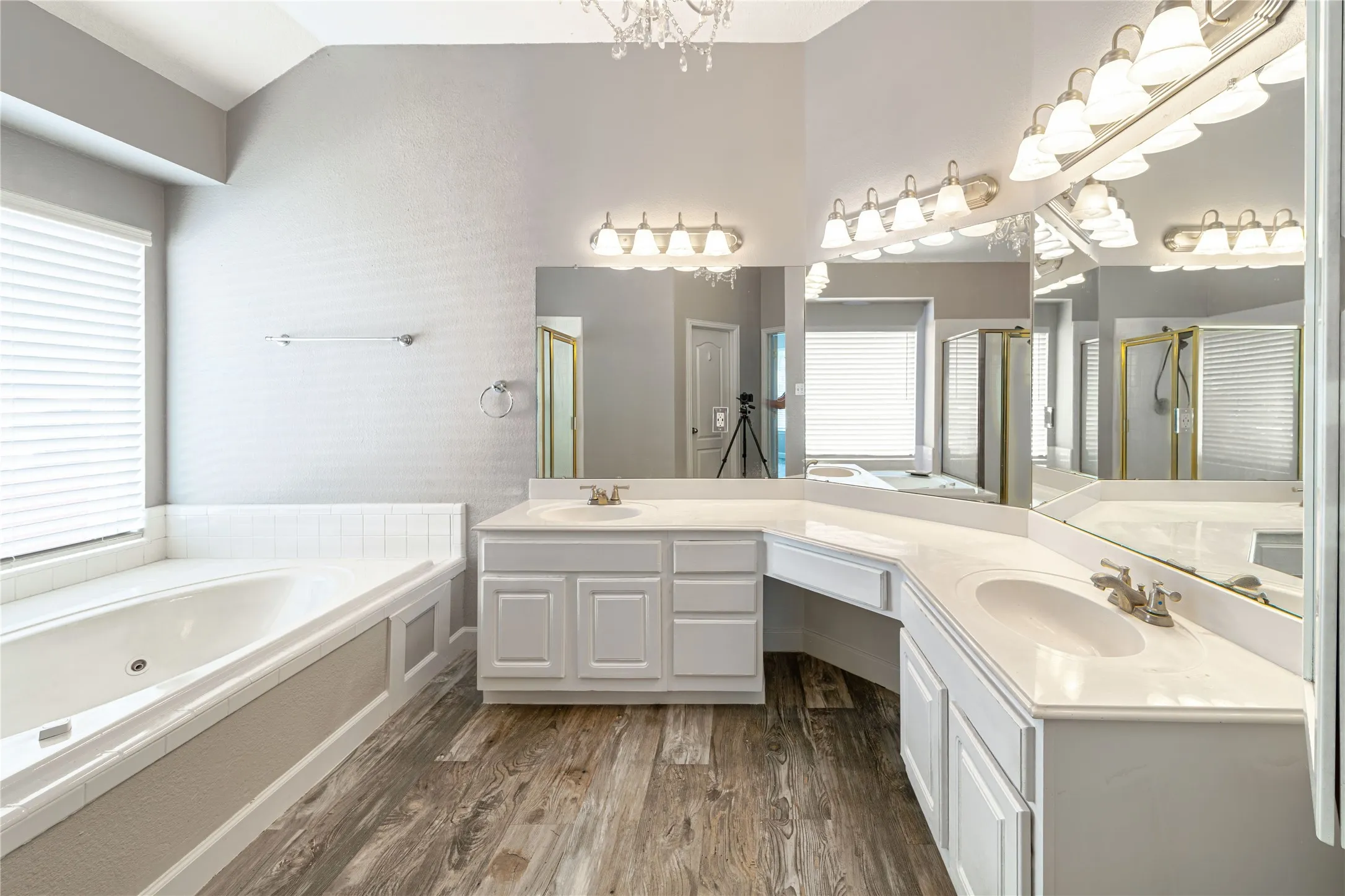 well lit master bath with dual sinks with plenty of storage.