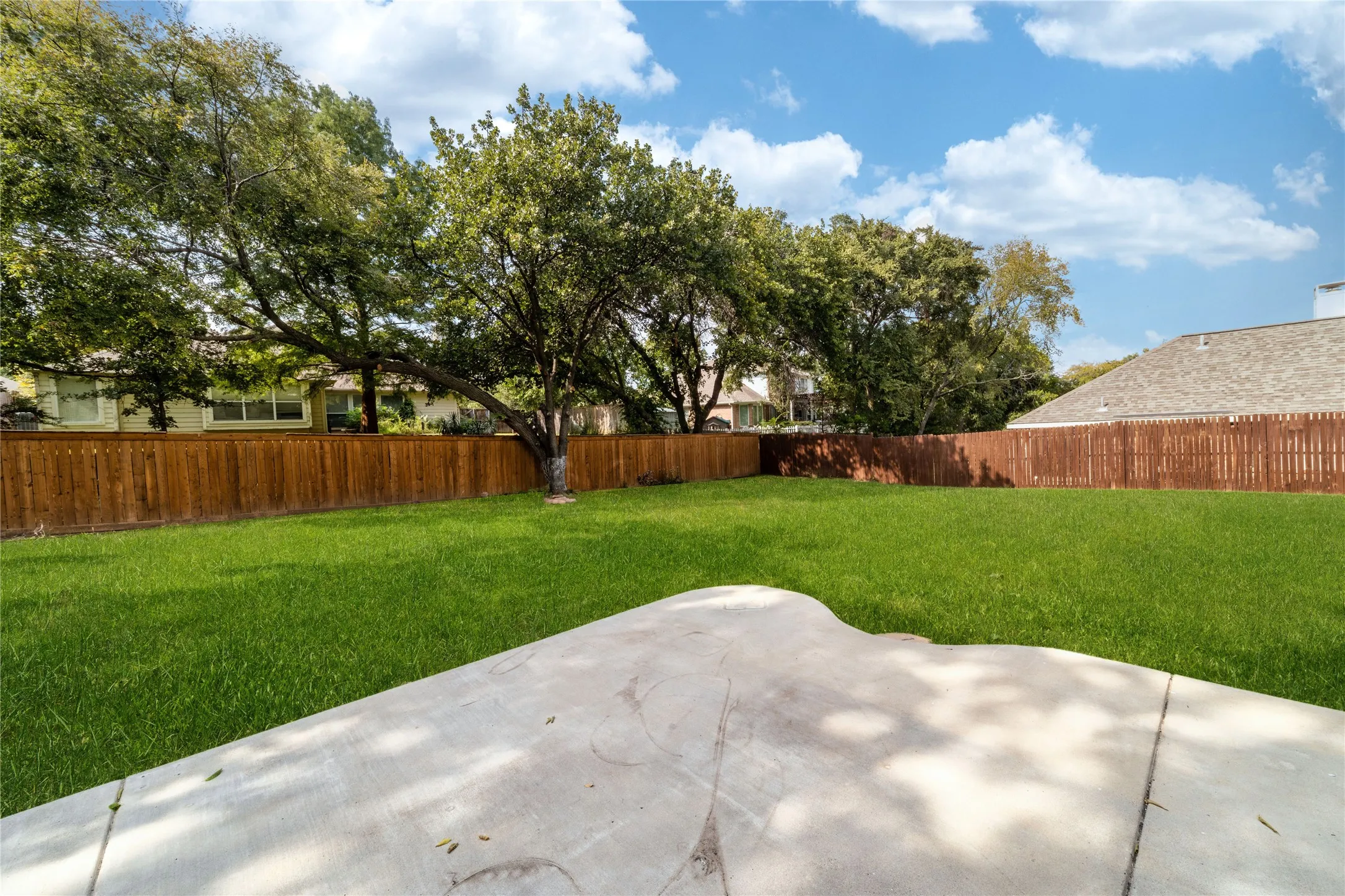 Fenced backyard featuring a patio area