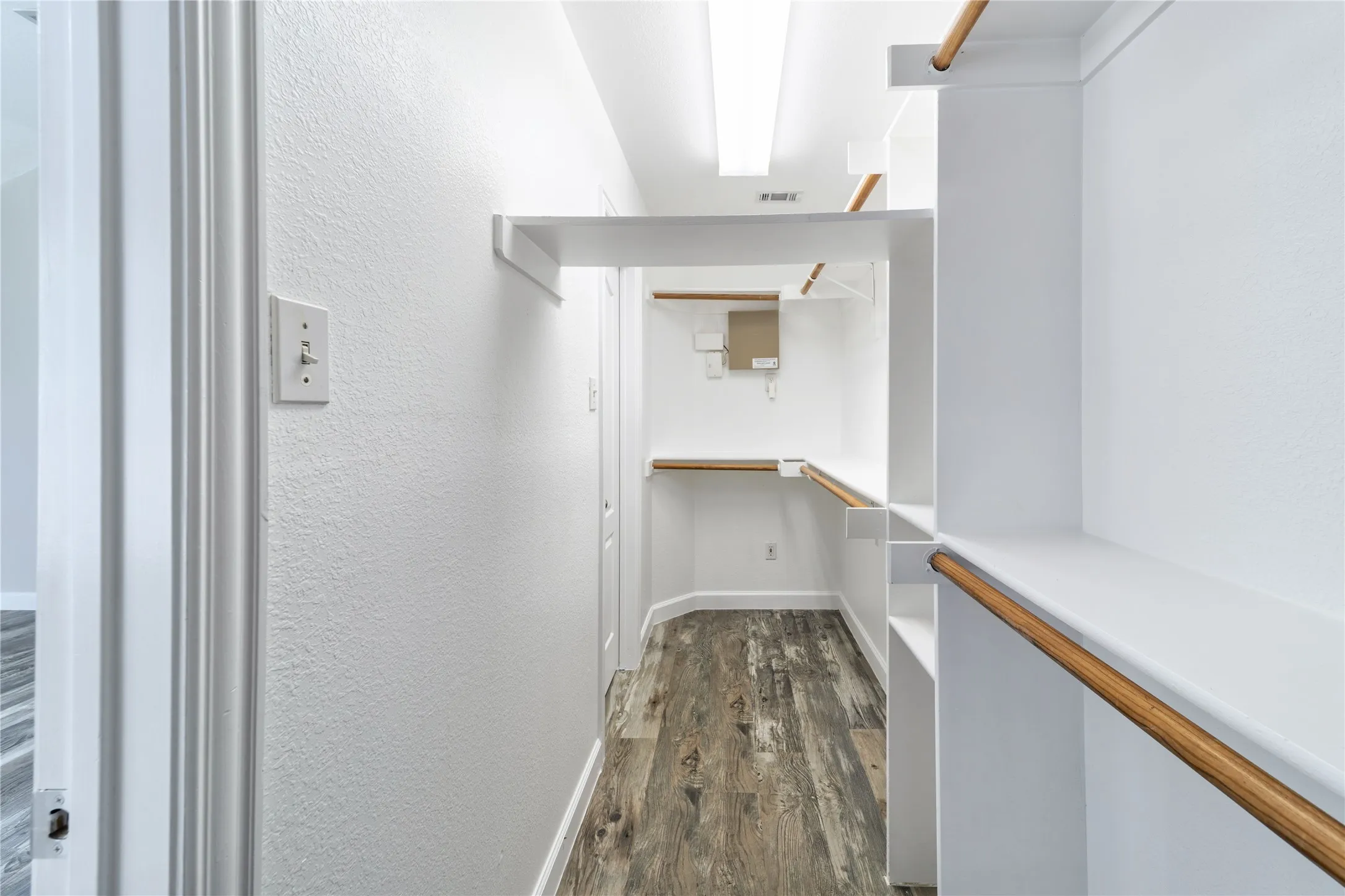 Spacious closet featuring enough room for both parties.