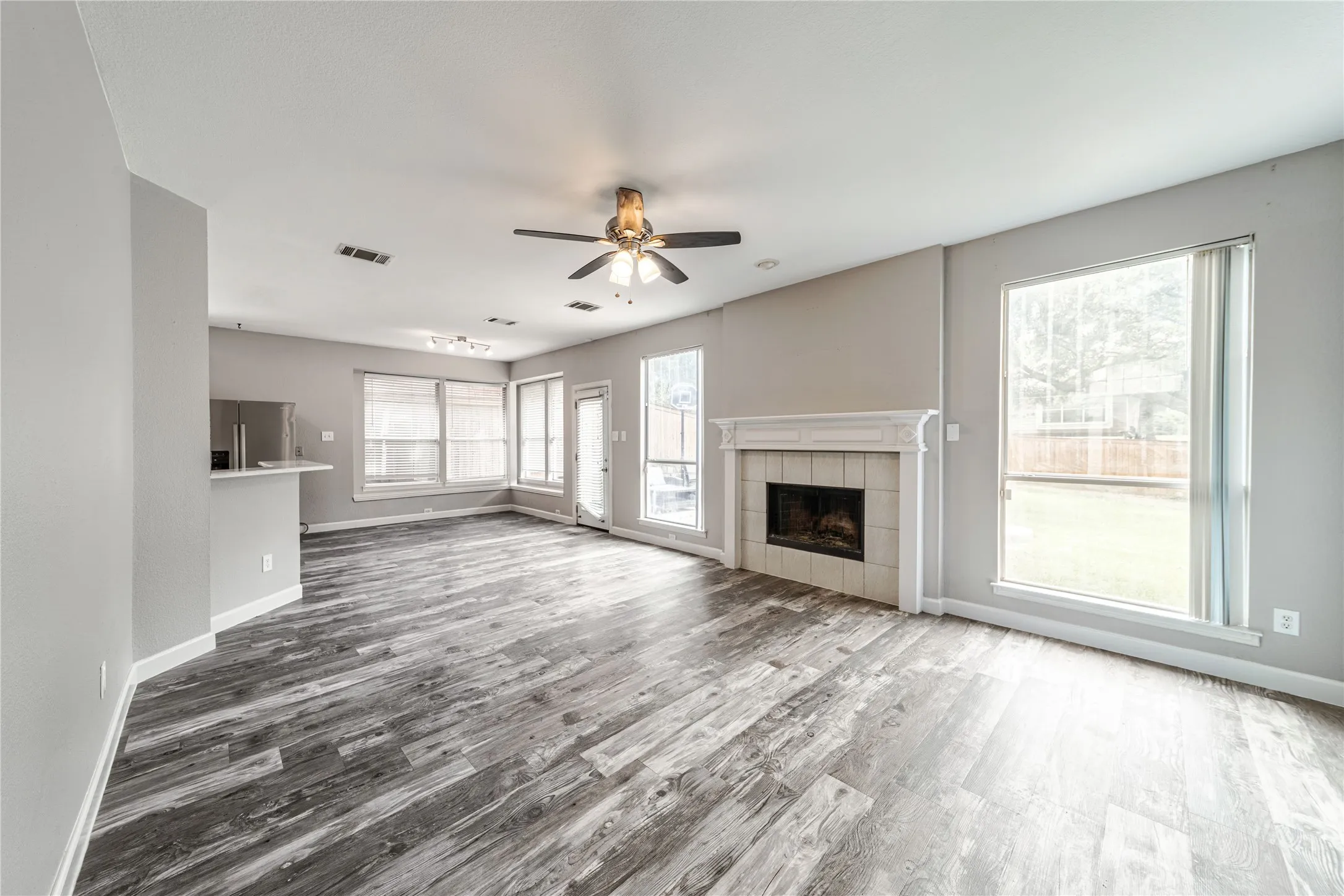  living room featuring wood burning fireplace. Eat in Kitchen.