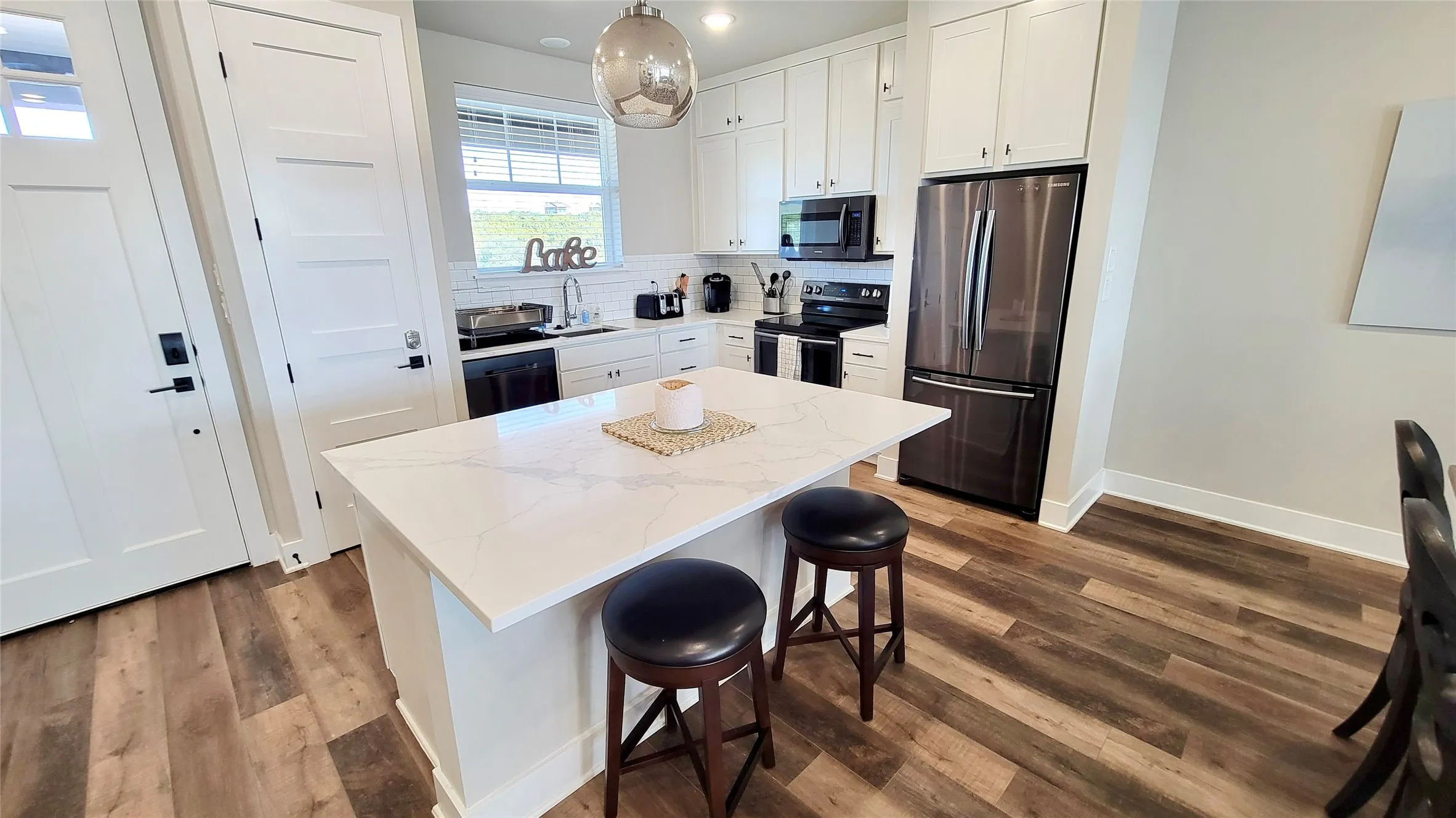 Open Concept Design Living with Stainless Appliances and Granite Counters