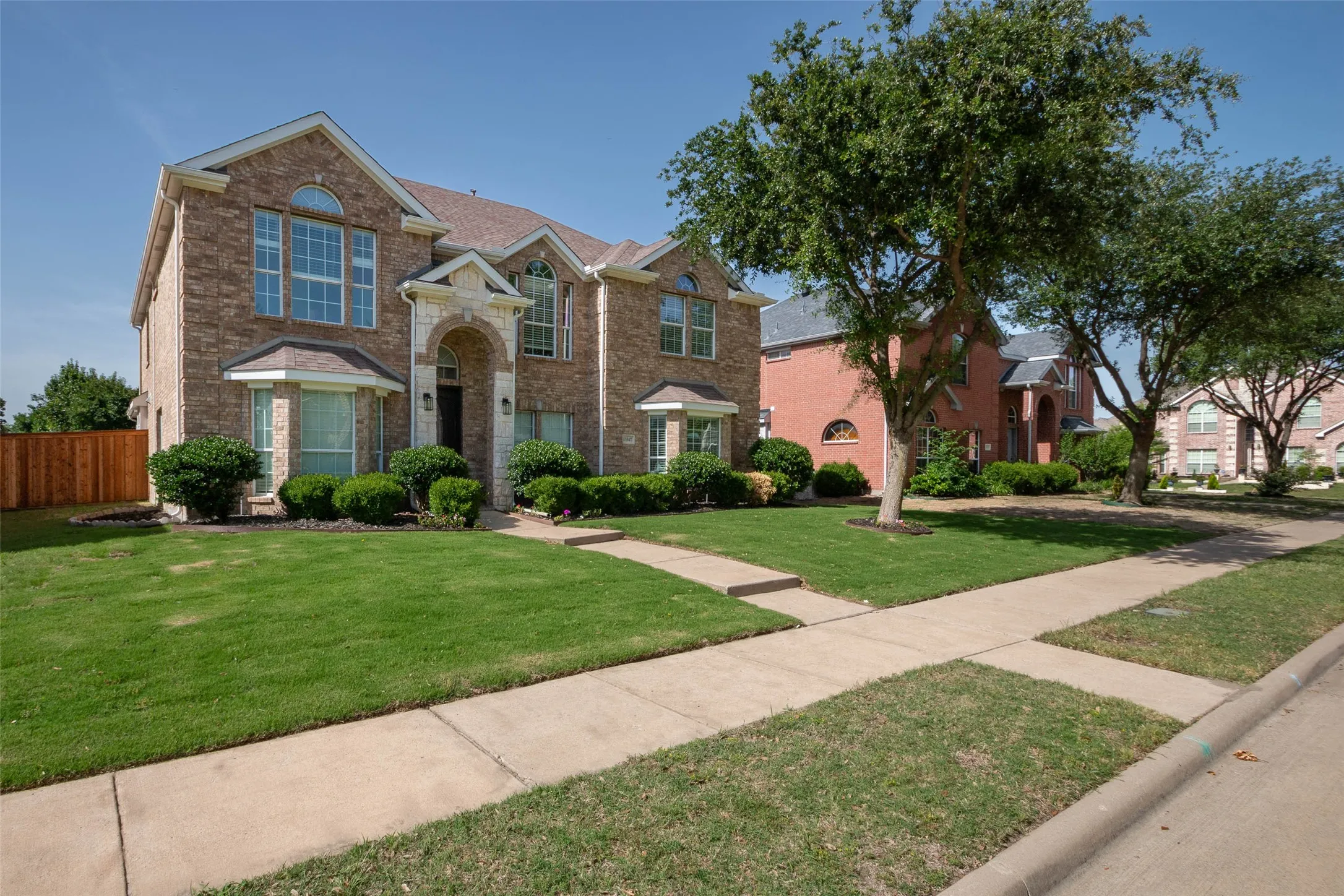 Traditional-style home with brick siding