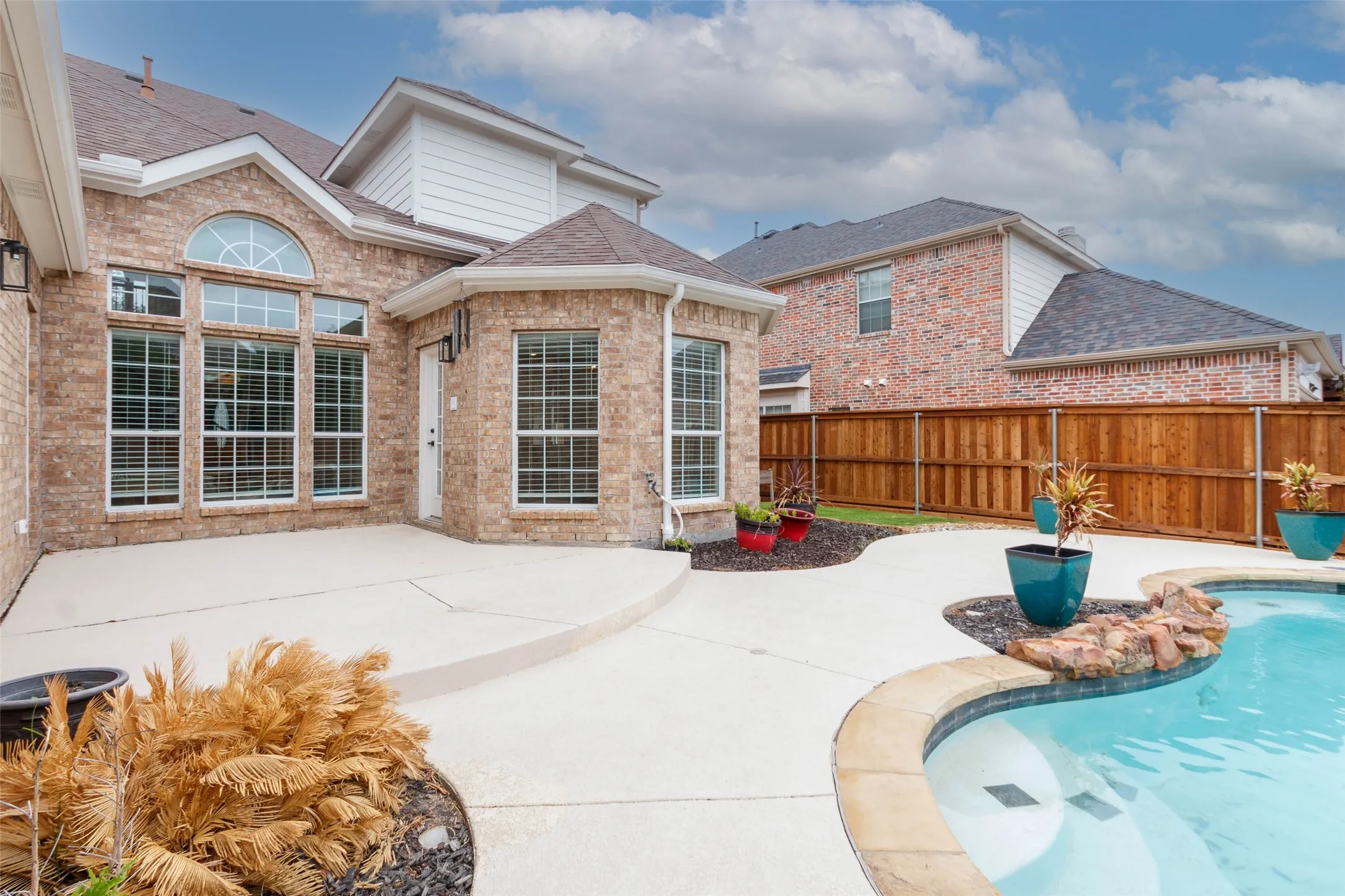 View of swimming pool featuring a patio and a fenced backyard