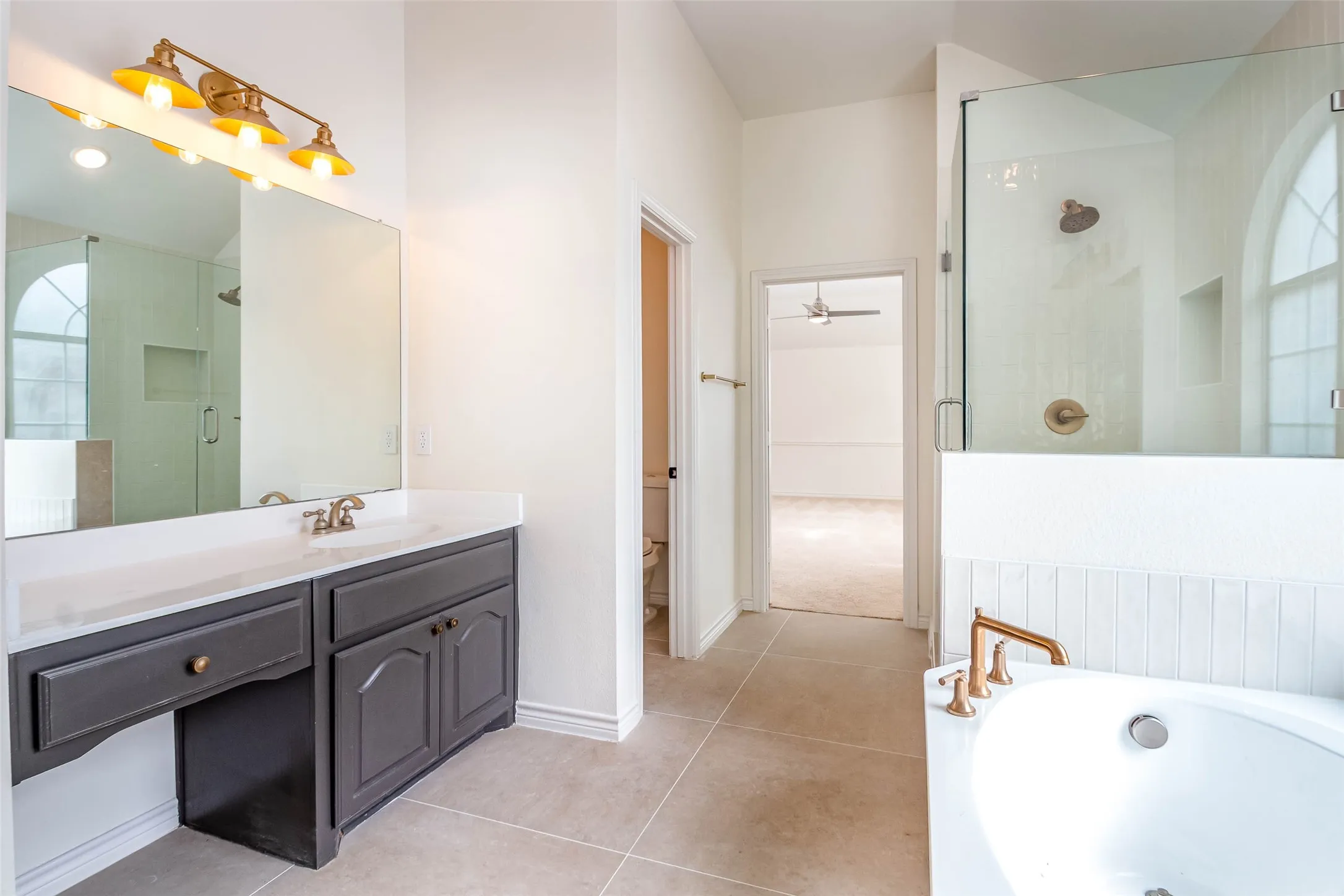 Full bathroom with a shower stall, vanity, a bath, and light tile patterned flooring