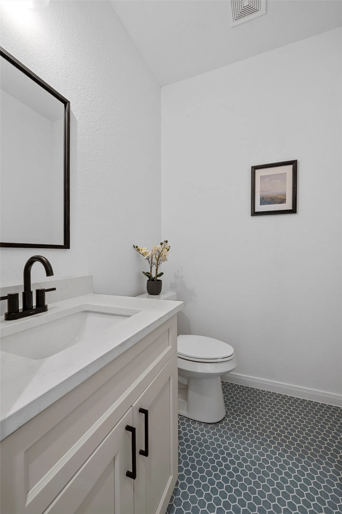 Bathroom featuring vanity and beautiful light blue tile floors