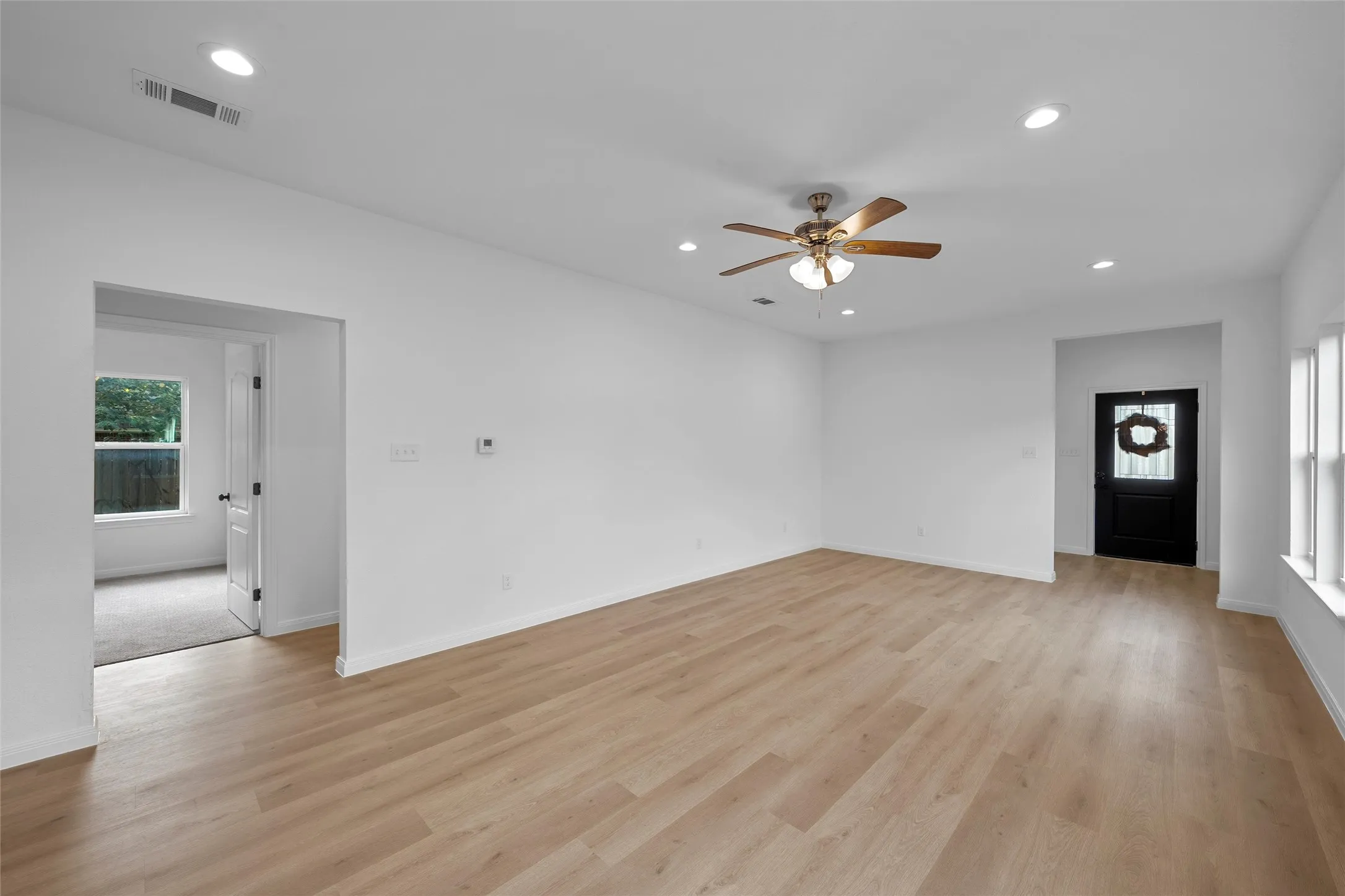 Unfurnished living room with recessed lighting, light wood-style flooring, and a ceiling fan