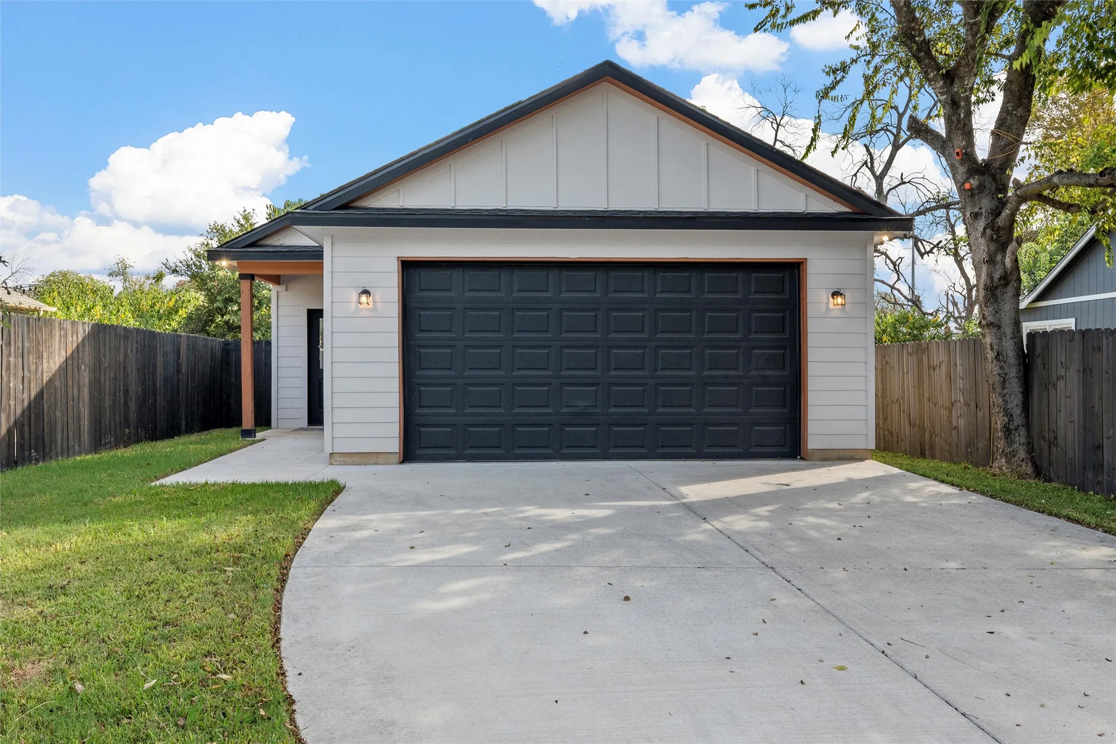 View of front facade with a front door garage entry.