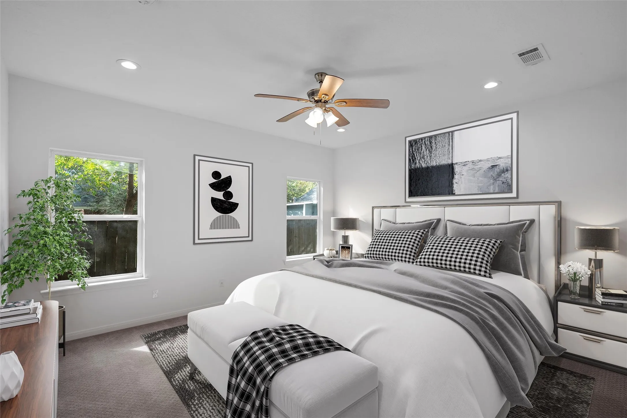 Picture virtually staged of the ample primary bedroom with carpet floors, ceiling fan, and recessed lighting