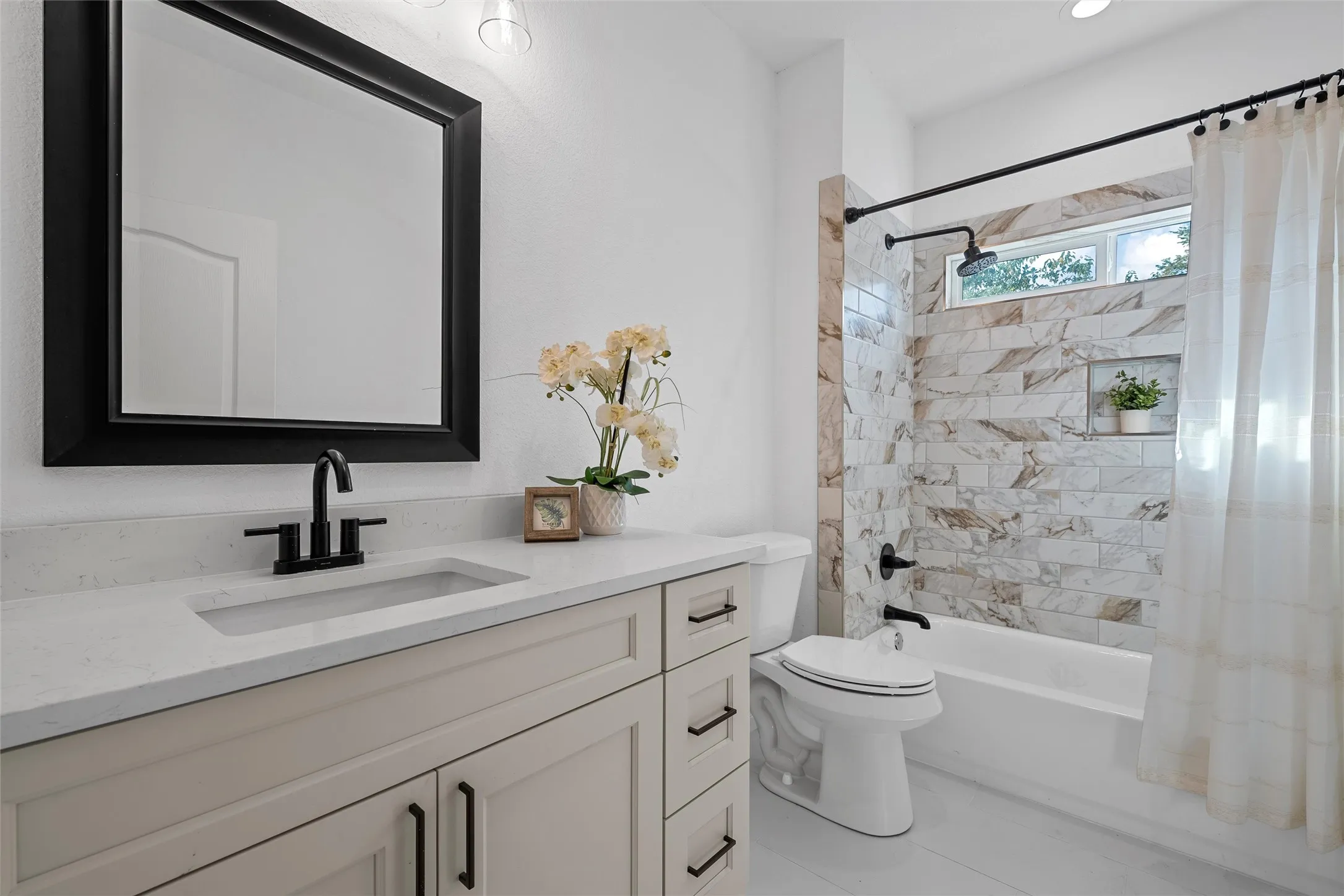 Bathroom featuring shower / tub combo and vanity