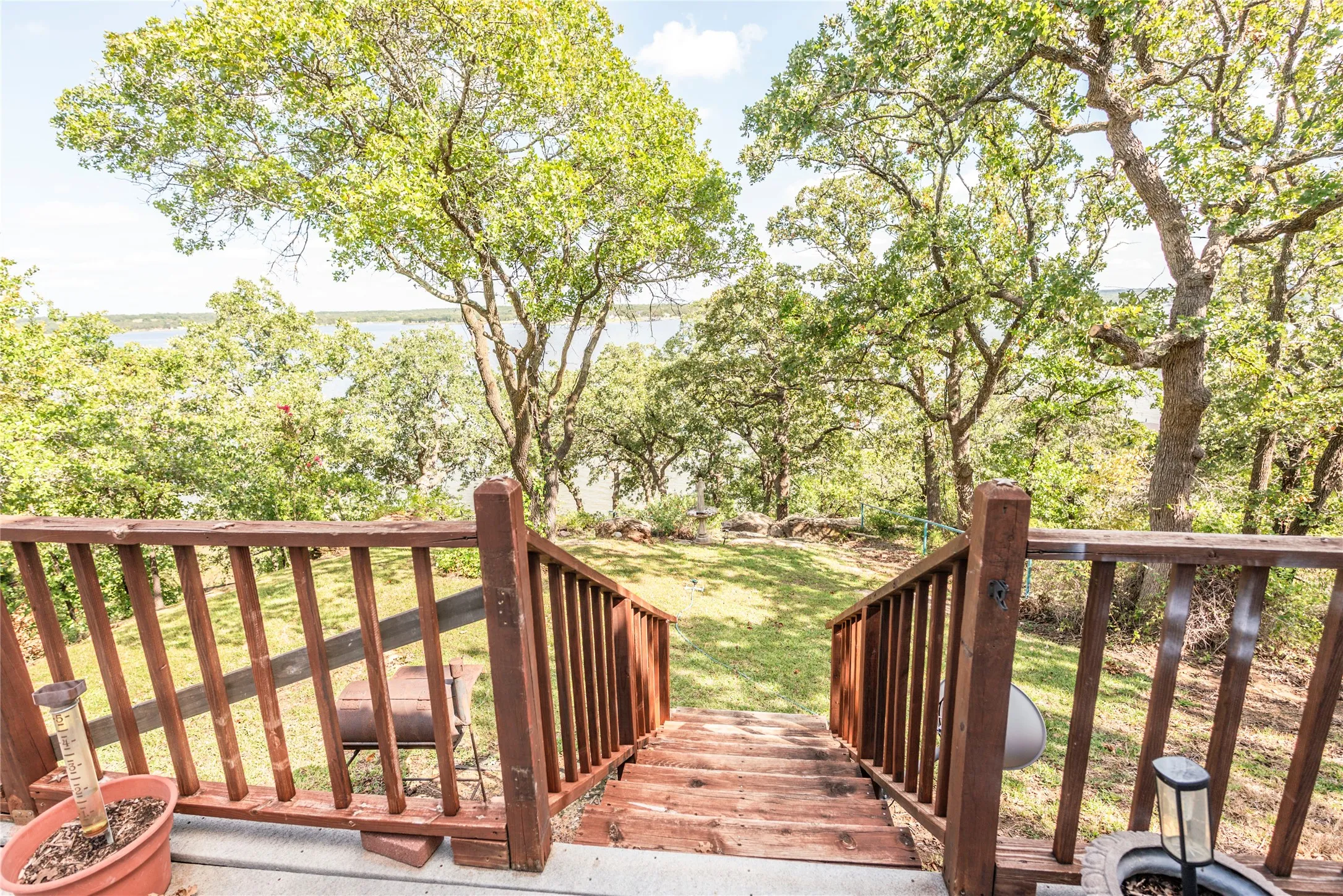 Wooden deck with a lawn and a water view