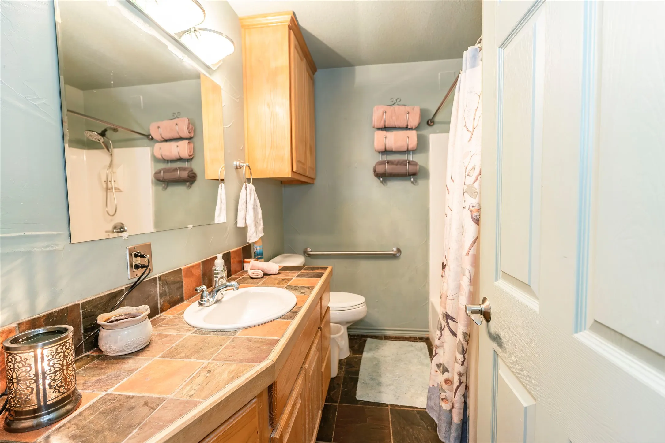 Full bath featuring vanity and a shower with shower curtain