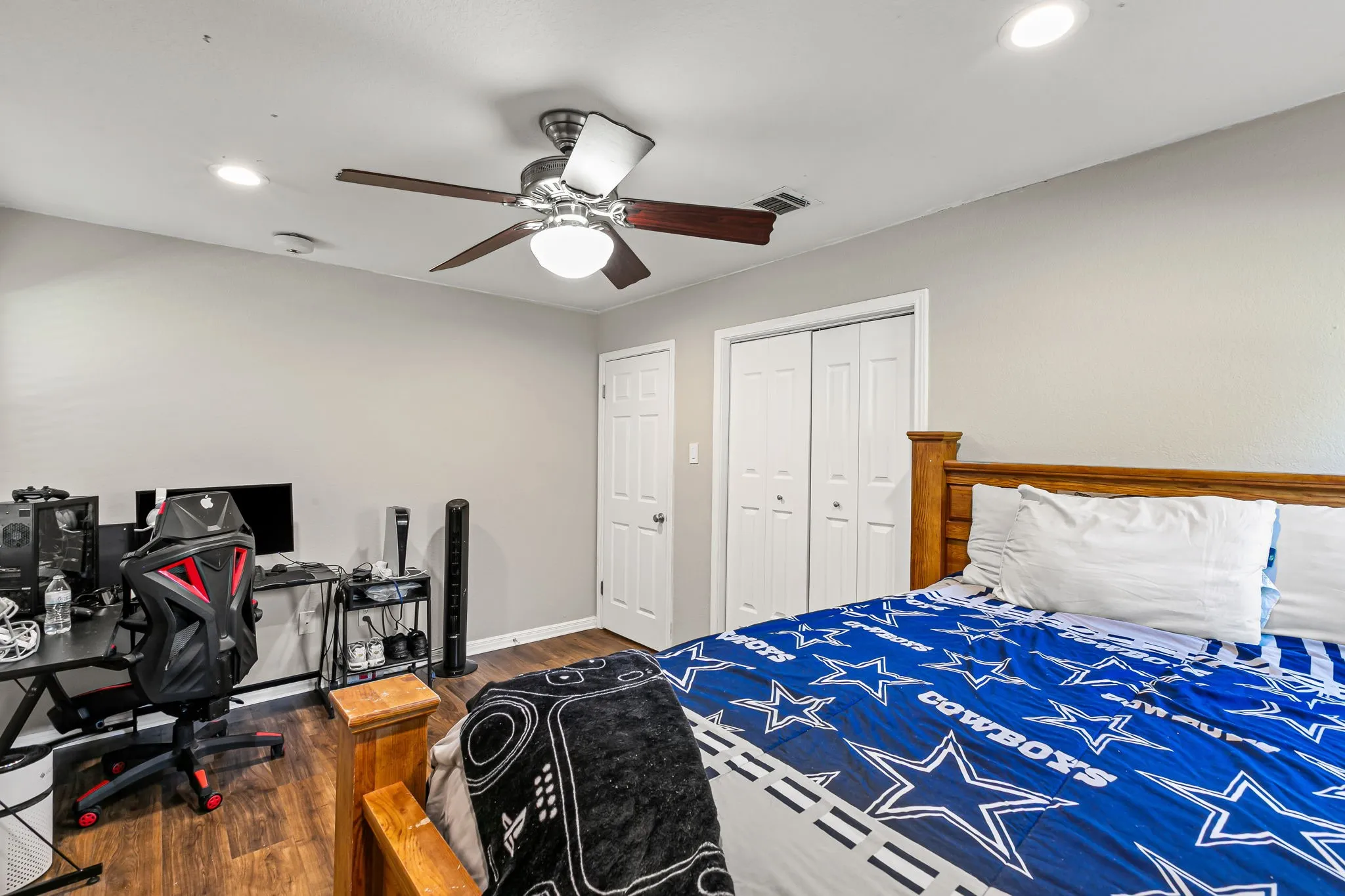 Bedroom with recessed lighting, wood finished floors, a ceiling fan, a desk, and a closet