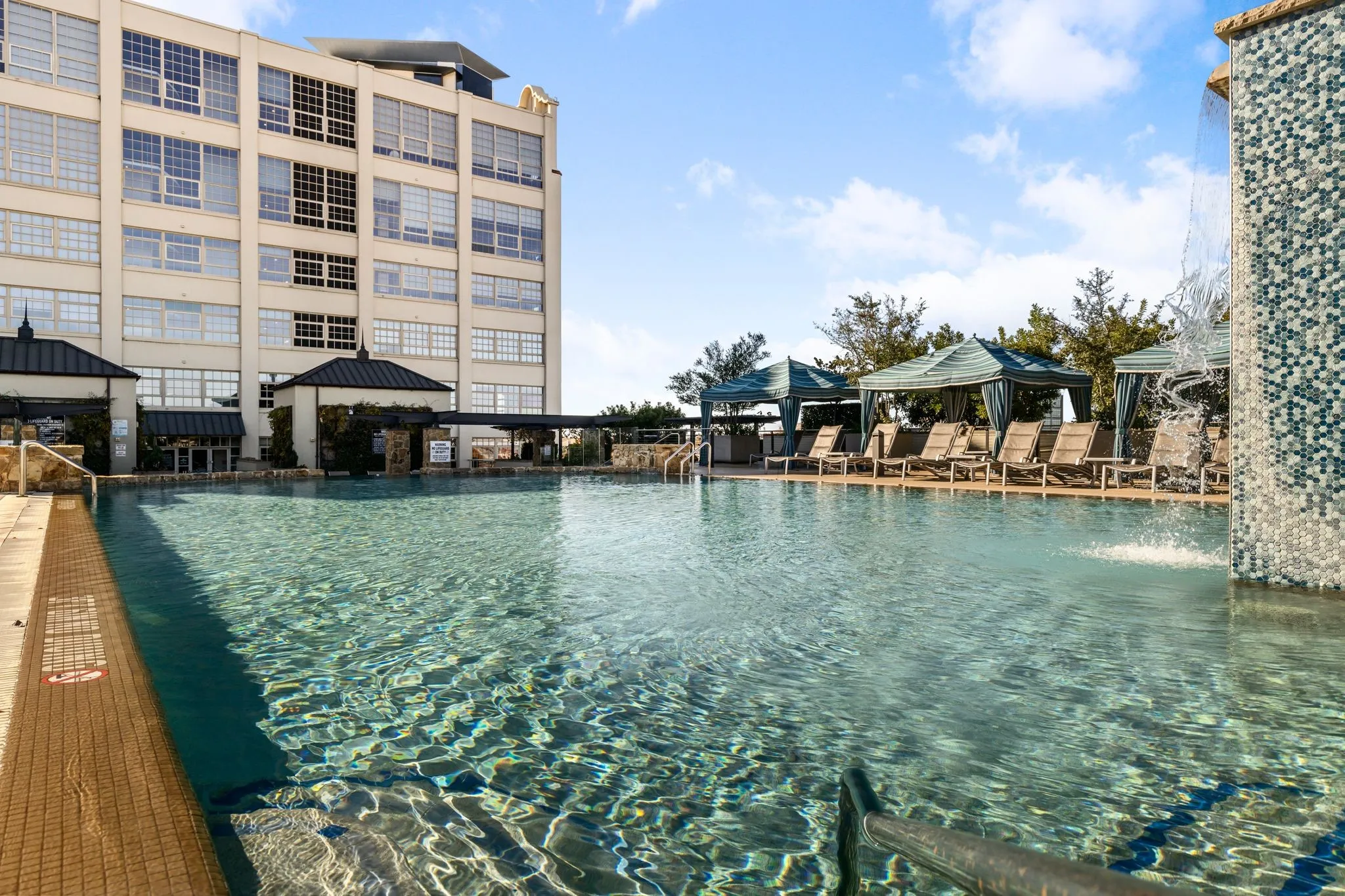 Community pool with a gazebo and a patio area