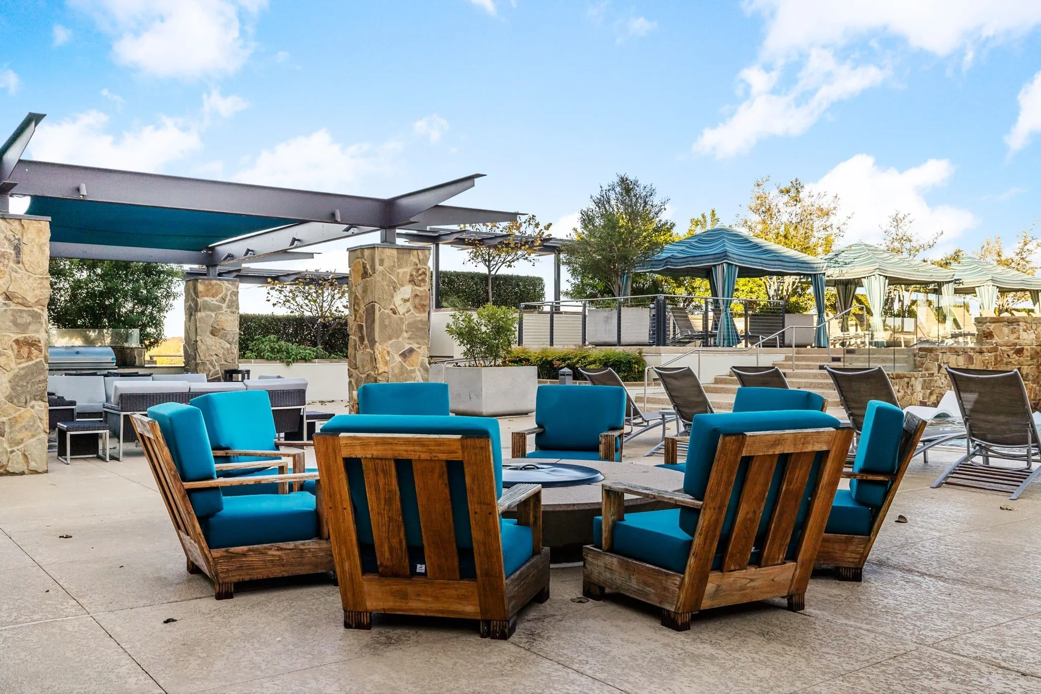 View of patio featuring an outdoor living space with a fire pit and an outdoor kitchen