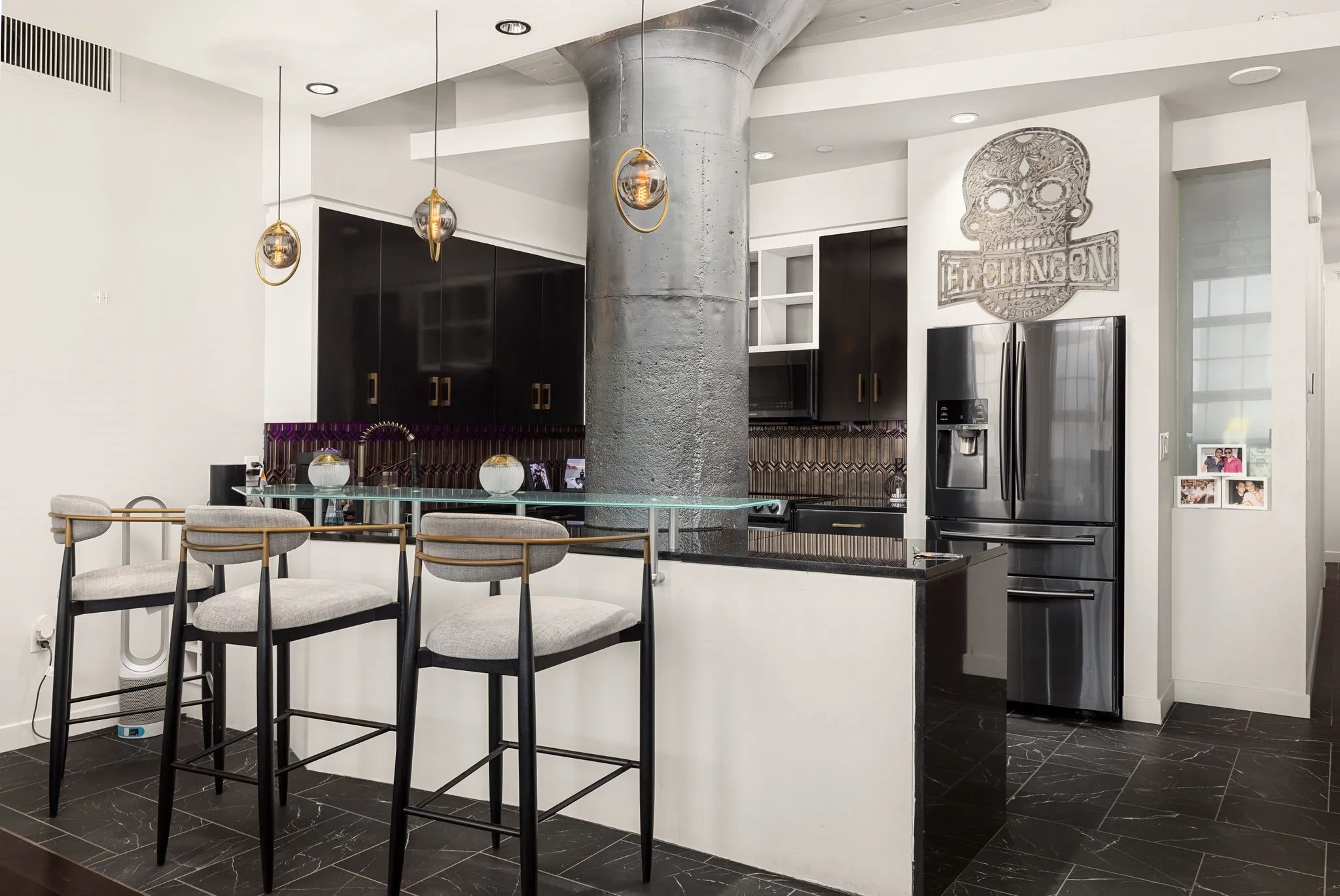 Kitchen with stainless steel fridge, pendant lighting, recessed lighting, decorative backsplash, and a breakfast bar