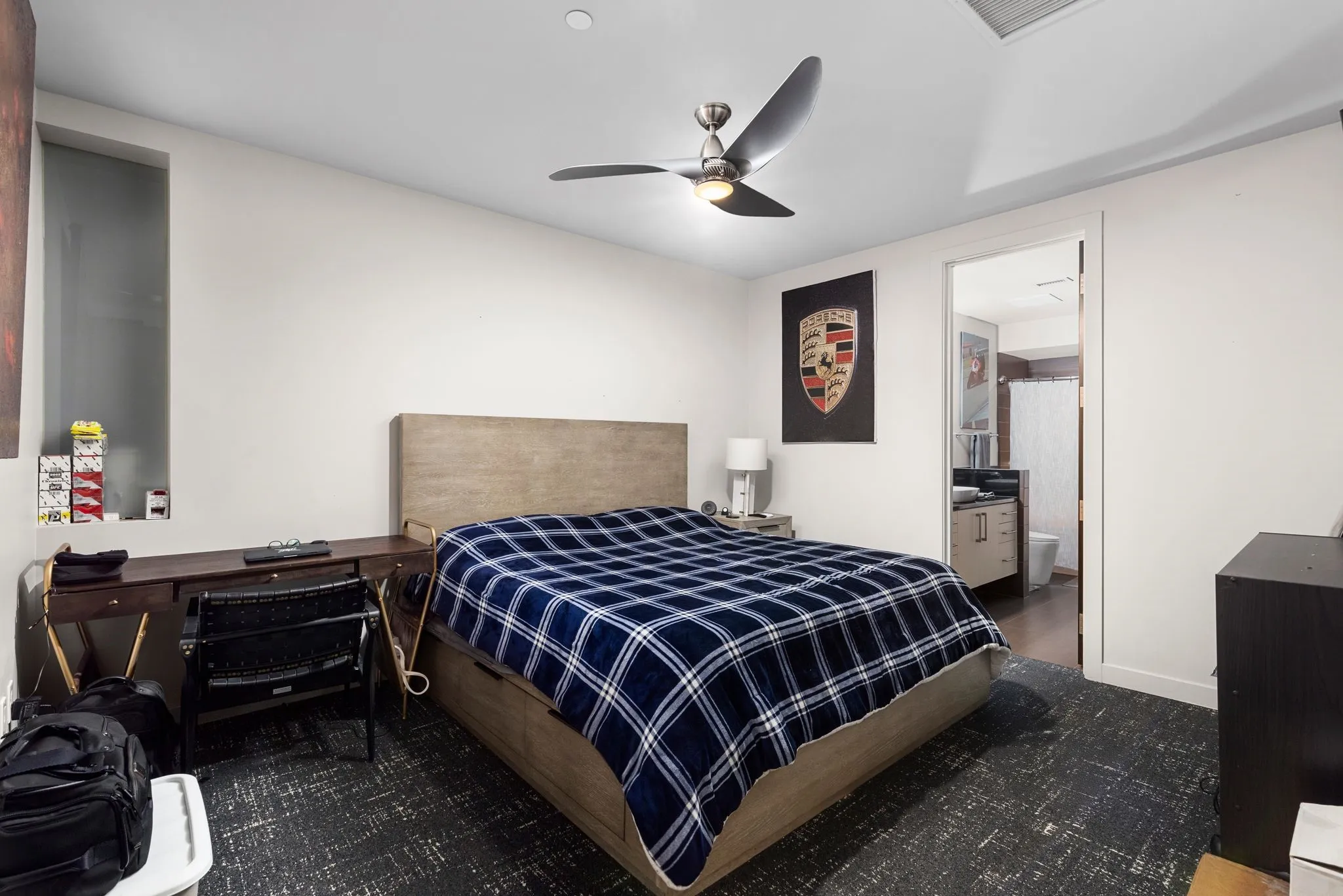 Bedroom with ensuite bathroom and a ceiling fan