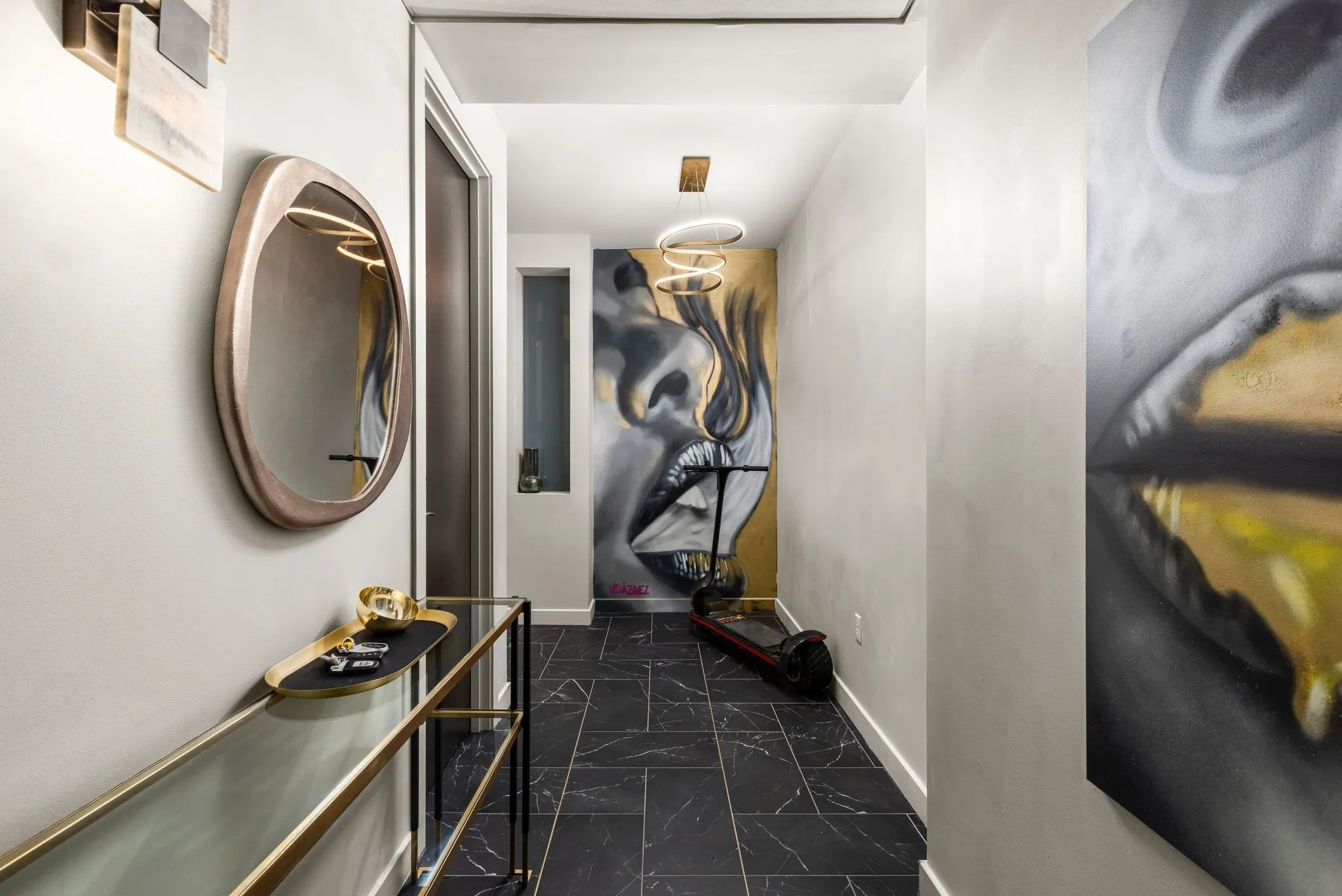 Corridor featuring dark marble finish flooring and baseboards