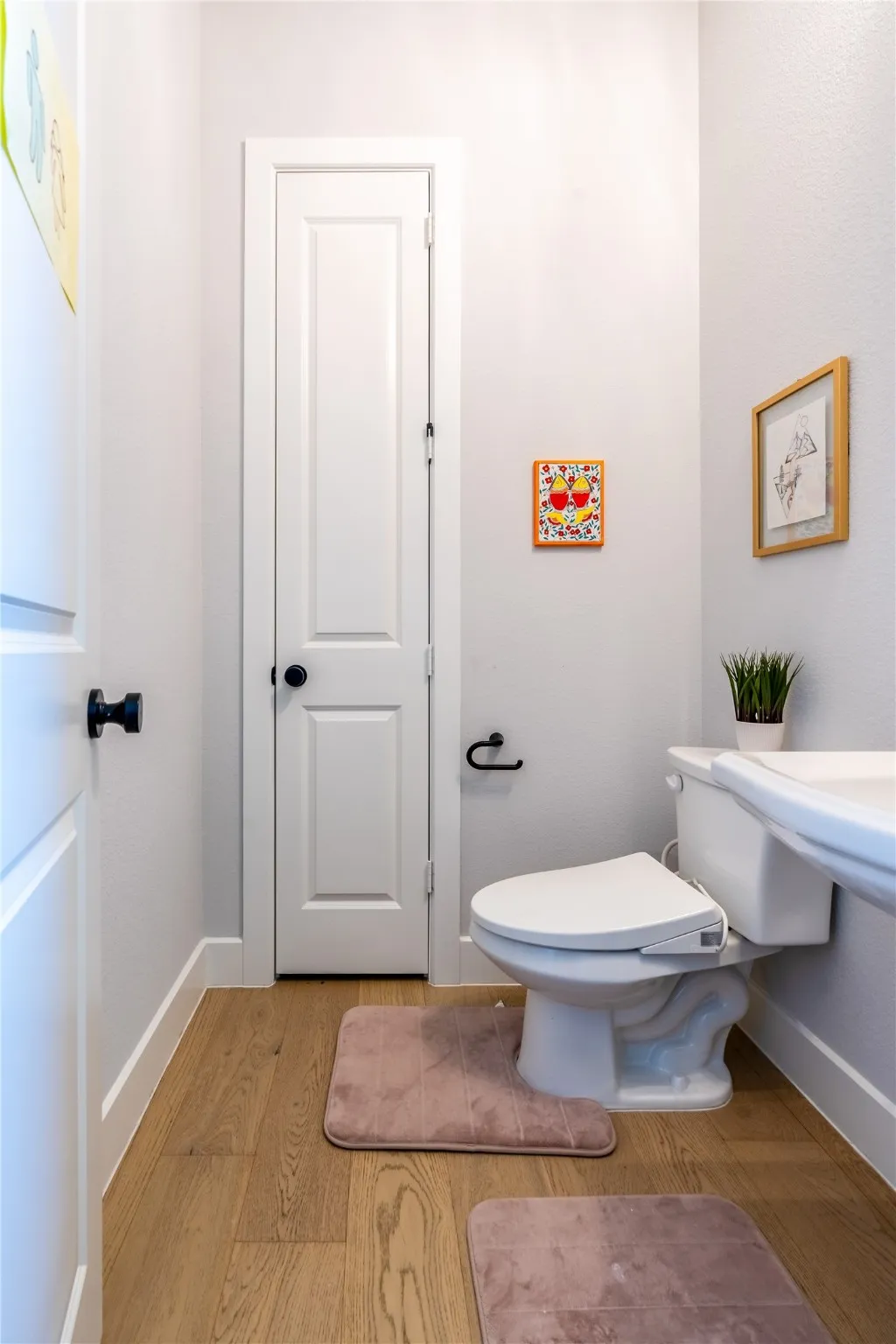 Bathroom featuring light wood finished floors and baseboards