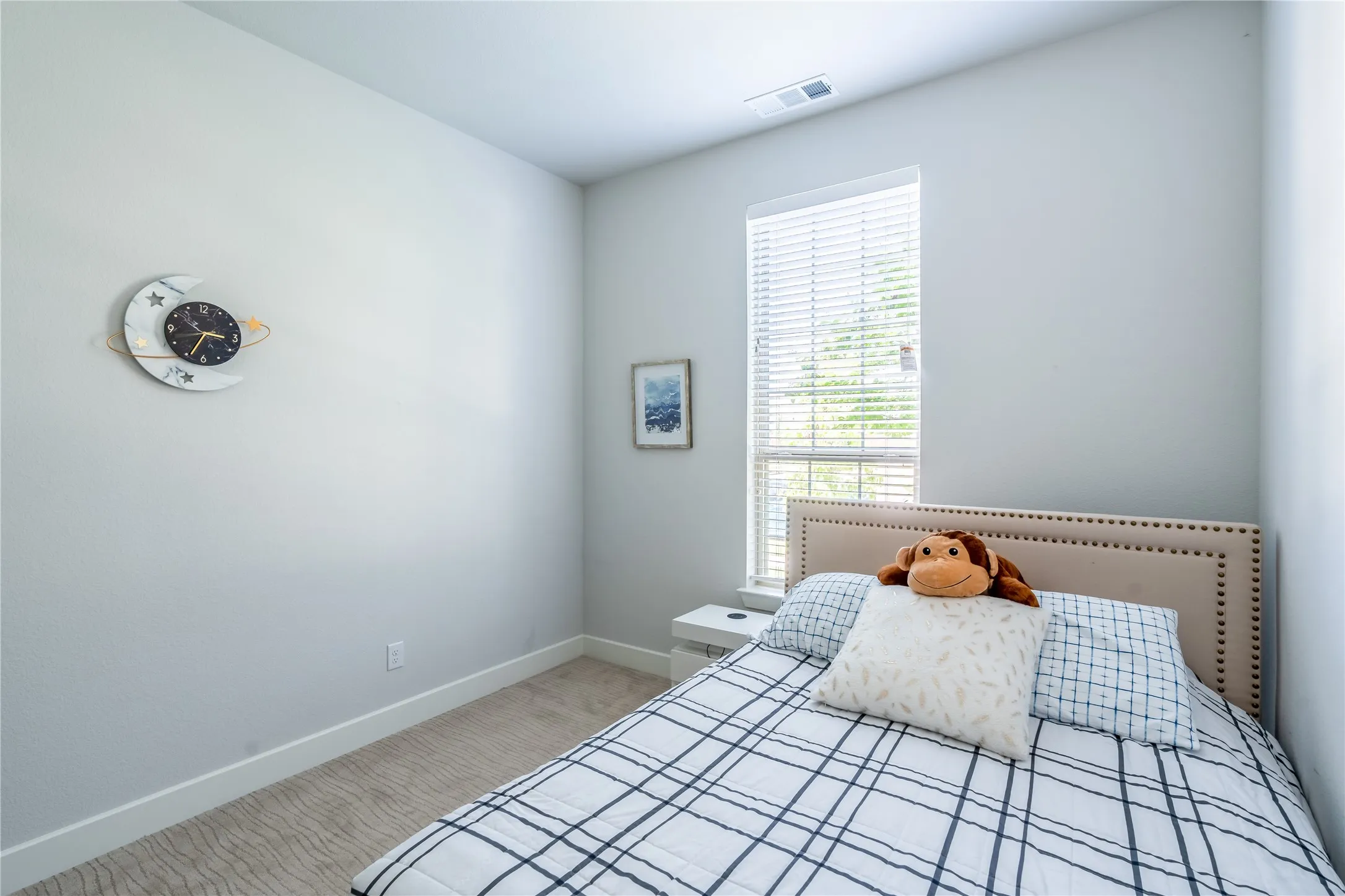 Bedroom with light carpet and baseboards