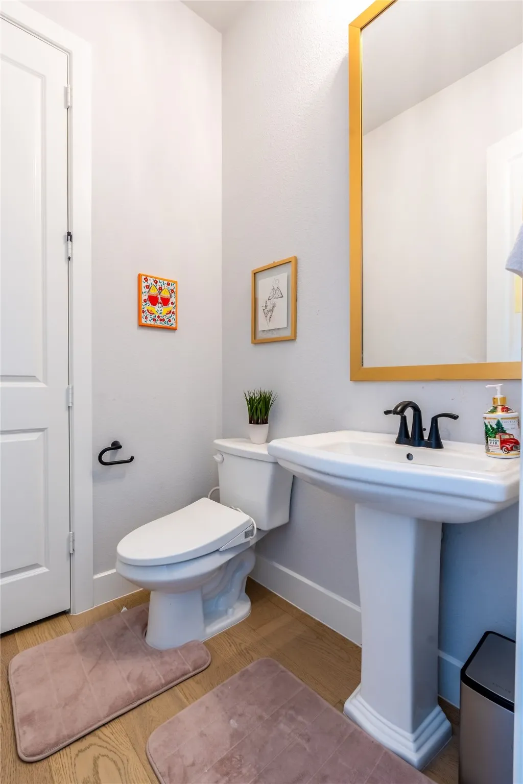 Bathroom featuring wood finished floors and baseboards