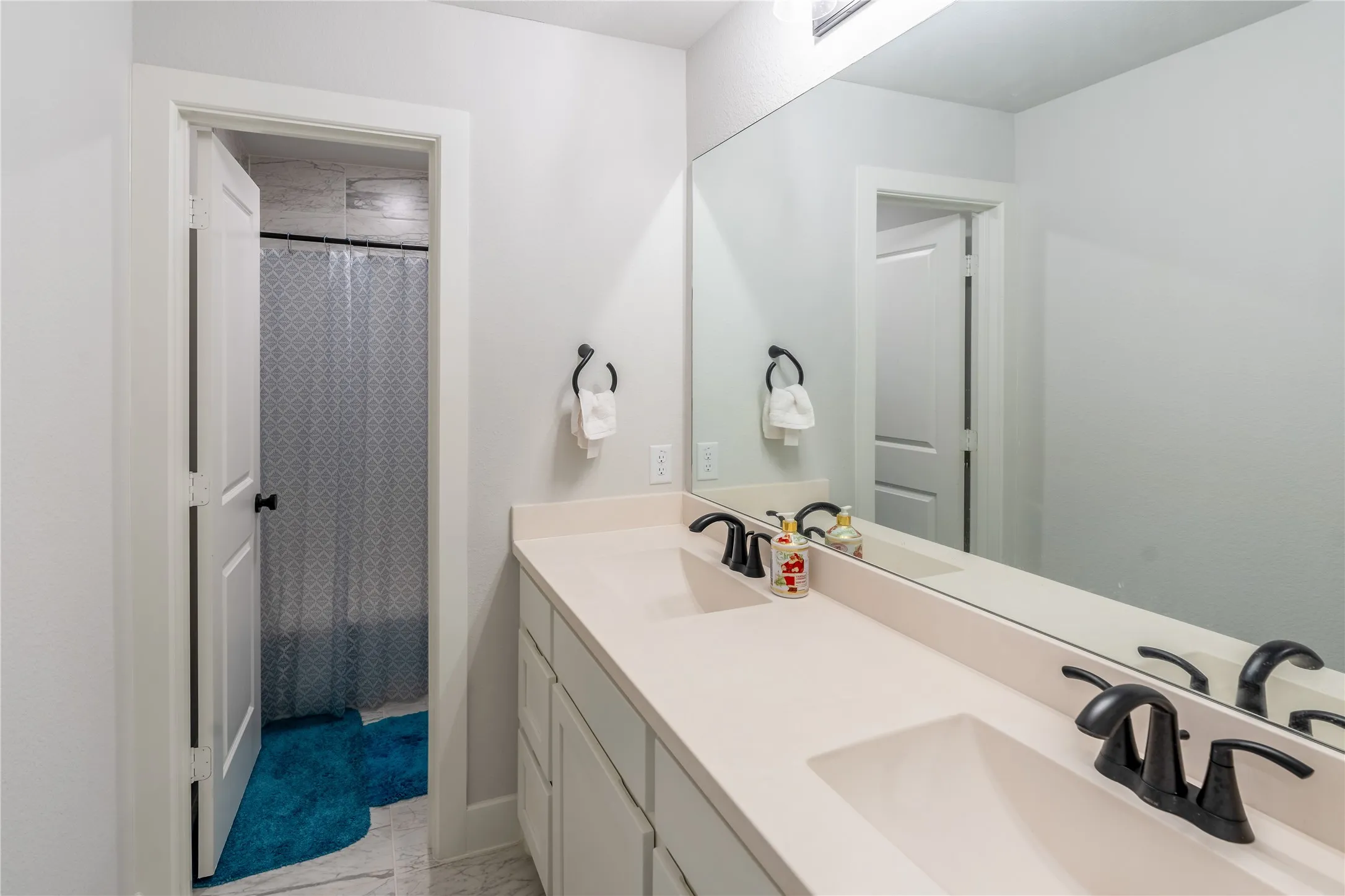 Full bath with double vanity and curtained shower